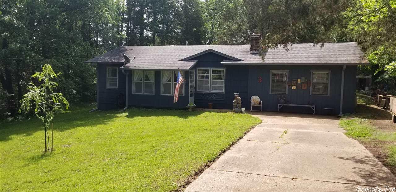REDUCED!! Well-cared for home with 3 bedrooms and 2 baths (1 full and a 3/4 bath). Wood burning fireplace in living room. Separate laundry room. level lot with rear patio. hardwood and vinyl flooring, no carpeting. Front porch enclosed and rear patio.  Sits privately near the North golf course and South Fork of the Spring River.  Cute as button and ready for you! Owner financing possible with acceptable terms.