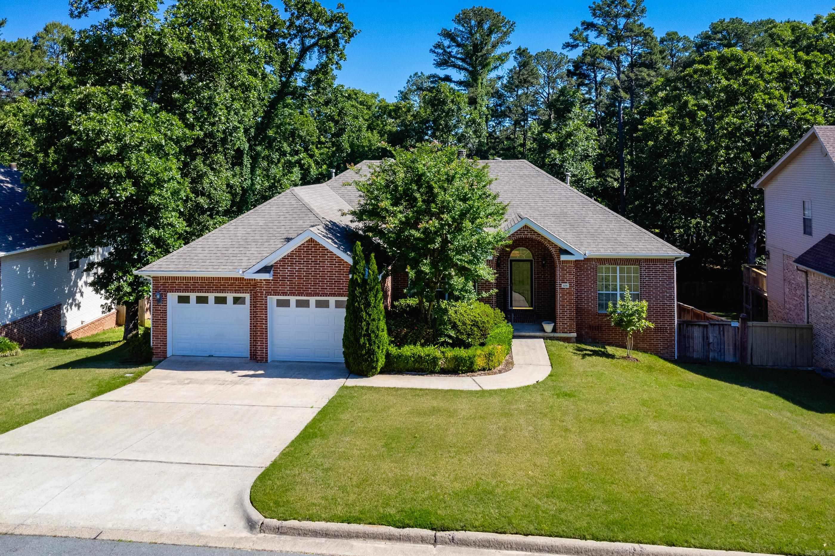 Beautiful one level home with a desirable split floor plan, open layout, and tall ceilings throughout. Fresh neutral paint and abundant natural light create a bright, welcoming feel from the moment you enter. Formal dining room opens to spacious living areas featuring a fireplace shared between the main living room and the family/hearth room just off the kitchen, making the spaces perfect for both entertaining and everyday living. Kitchen offers granite countertops, newly updated stainless appliances including an induction range, dishwasher, and microwave, along with new light fixtures in both the kitchen and dining room. Private primary suite features a vaulted ceiling and an updated spa inspired bath, separated from two guest bedrooms and a hall bath for added privacy. Step outside to covered and uncovered multi level decks overlooking the inground pool and beautifully landscaped, wooded, fully fenced backyard. Under house storage is a plus. Charming, comfortable, and easy to live in, this move in ready home offers wonderful indoor and outdoor living spaces in a lovely setting. Come see!