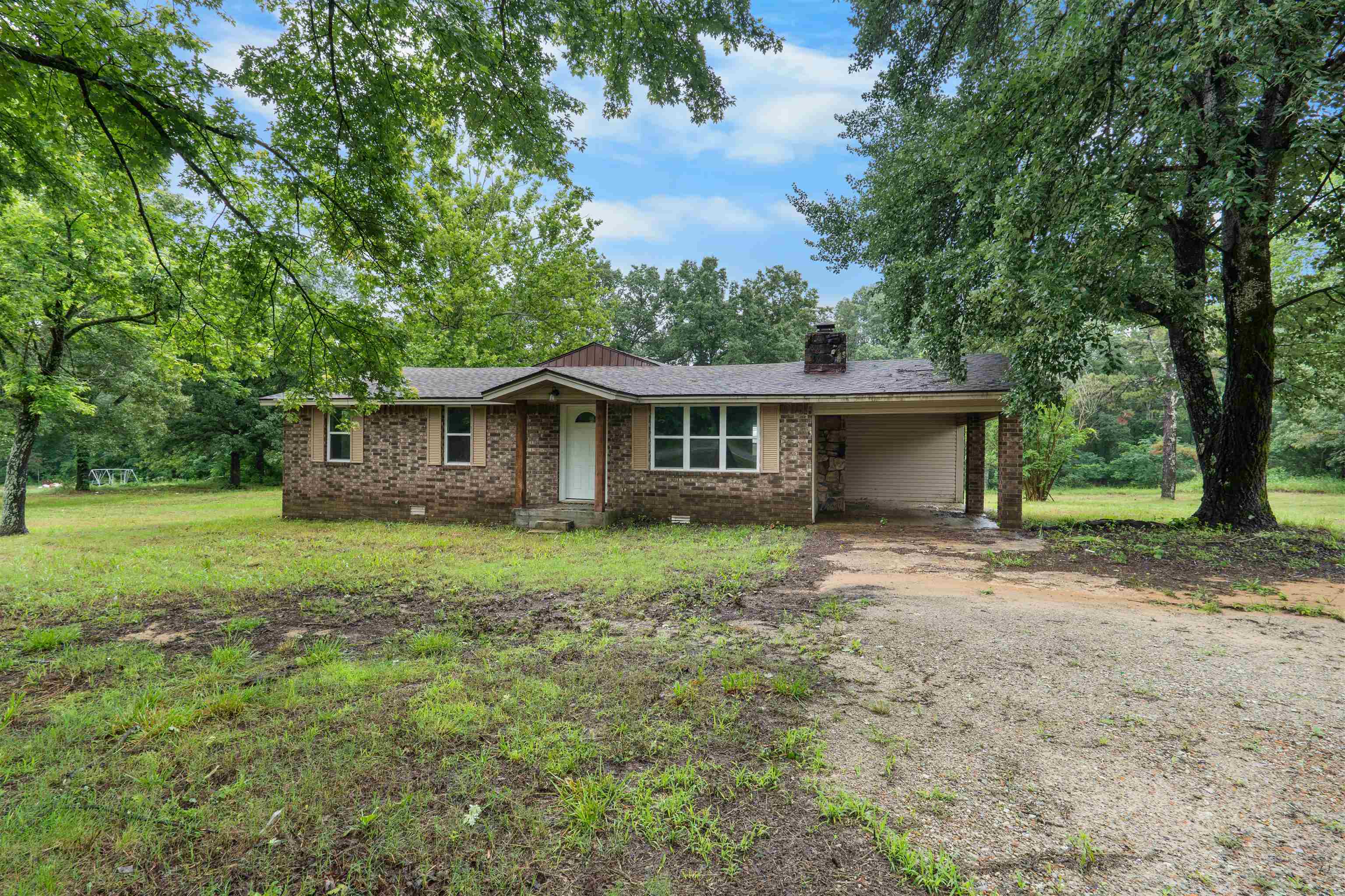 Completely remodeled 4-bedroom, 2-bath home on 10 acres! This move-in ready property features a spacious living room with vaulted ceilings and a wood-burning fireplace. The kitchen offers granite countertops, a large island, and new stainless steel appliances. The private master suite includes a walk-in closet and attached full bathroom, while the guest bedrooms are located on the opposite side of the home. Recent updates include a new roof, new central heat and air, new septic system, new flooring throughout, fresh paint, updated fixtures, and more. The property is mostly wooded, has a pond, & an older barn!  If you're looking for acreage and a beautifully updated home, this one is a must-see!