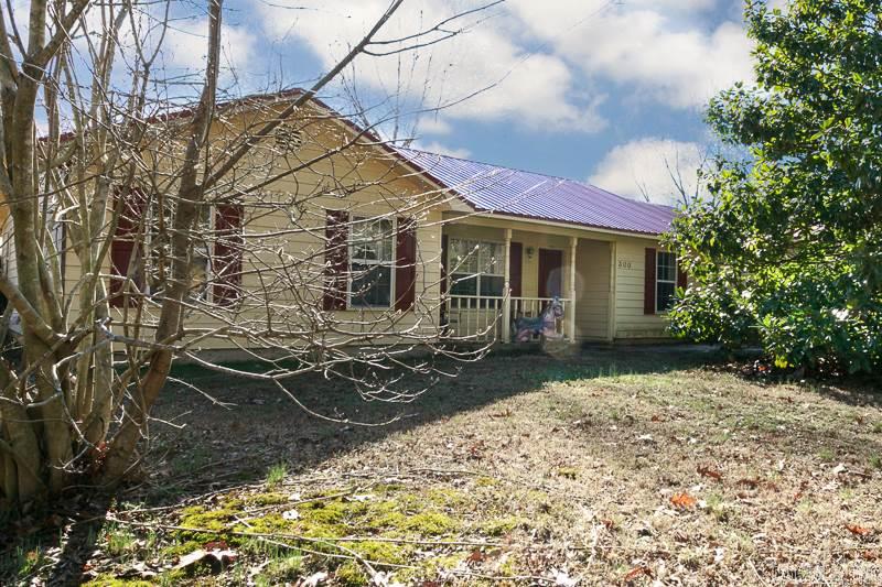 Great home close to shopping and schools. This 4 bedroom, 2 bath home located on a corner lot has a great kitchen/dining combo and large living room with a cozy fireplace. This split floor plan has nice room sizes.  The master bedroom has a huge walk in closet.   New metal roof installed in 2015.  With a little TLC, this would be a perfect starter home or investment property!  You don't want to miss this!