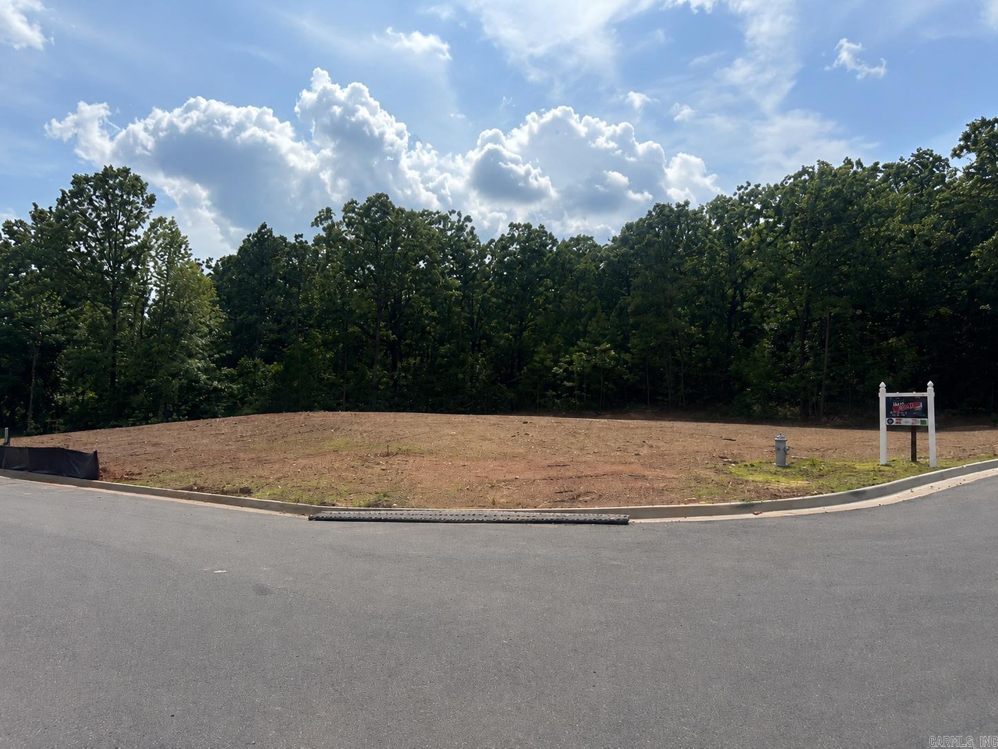 Build your dream home on this beautiful cleared lot with a scenic wooded backdrop. The homesite offers a peaceful setting surrounded by mature trees while still being conveniently located near shopping, dining, and everyday conveniences. A great opportunity to create a custom home in an established neighborhood setting.