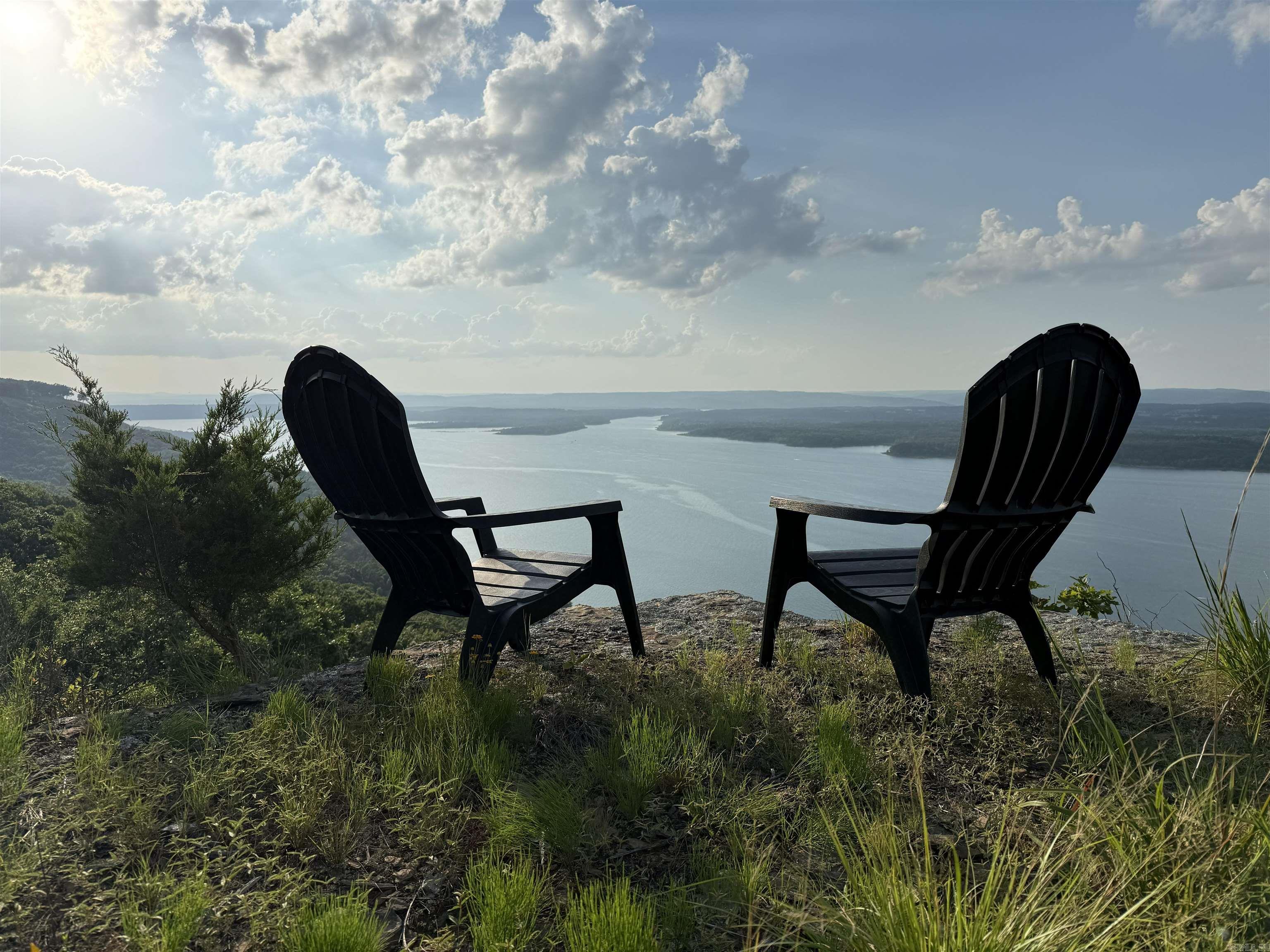 Perched high above Greers Ferry Lake, this extraordinary 1-acre bluff property delivers a rare combination of panoramic beauty, privacy, and location. Sweeping views of the lake and surrounding Ozark Mountains, this kind of setting inspires a custom home unlike any other. Begin your mornings with coffee on the bluff as the sunrise spills across the water, end each day with a stunning sunset over Sugar Loaf Mountain, where golden light stretches across the lake, the glowing Narrows Historic Truss Bridge. On top of the property enjoy a view of the other side of the lake, with broader wintertime visibility, adding to the uniqueness of this remarkable site. Ideally located close to boat launches, marinas, and a private airstrip, the property offers easy access while still feeling peaceful and secluded. Sound of boats below, the sight of eagles soaring overhead, the natural beauty of local wildlife create an atmosphere that is both relaxing and unforgettable. Whether you are building a luxury retreat, retirement haven, forever home, this rare bluff property offers the perfect canvas for your vision and a chance to own a truly spectacular piece of Lake Life, Be sure to click on the video