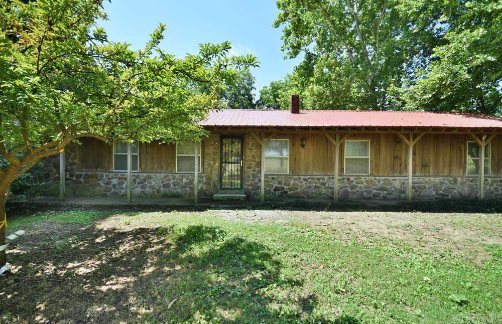 This cedar and stone house is a gardener's delight. Detached garage, workshops, barn with stables, extensive water system w/ frost proof faucets, 2 stocked ponds, cross-fenced, mature fruit and grafted pecan trees,  All plumbing and electrical has been upgraded. New windows, hot water heater, and brand new metal roof. Termite Contract since day 1. Working well on the grounds. This is one you will want to go see.