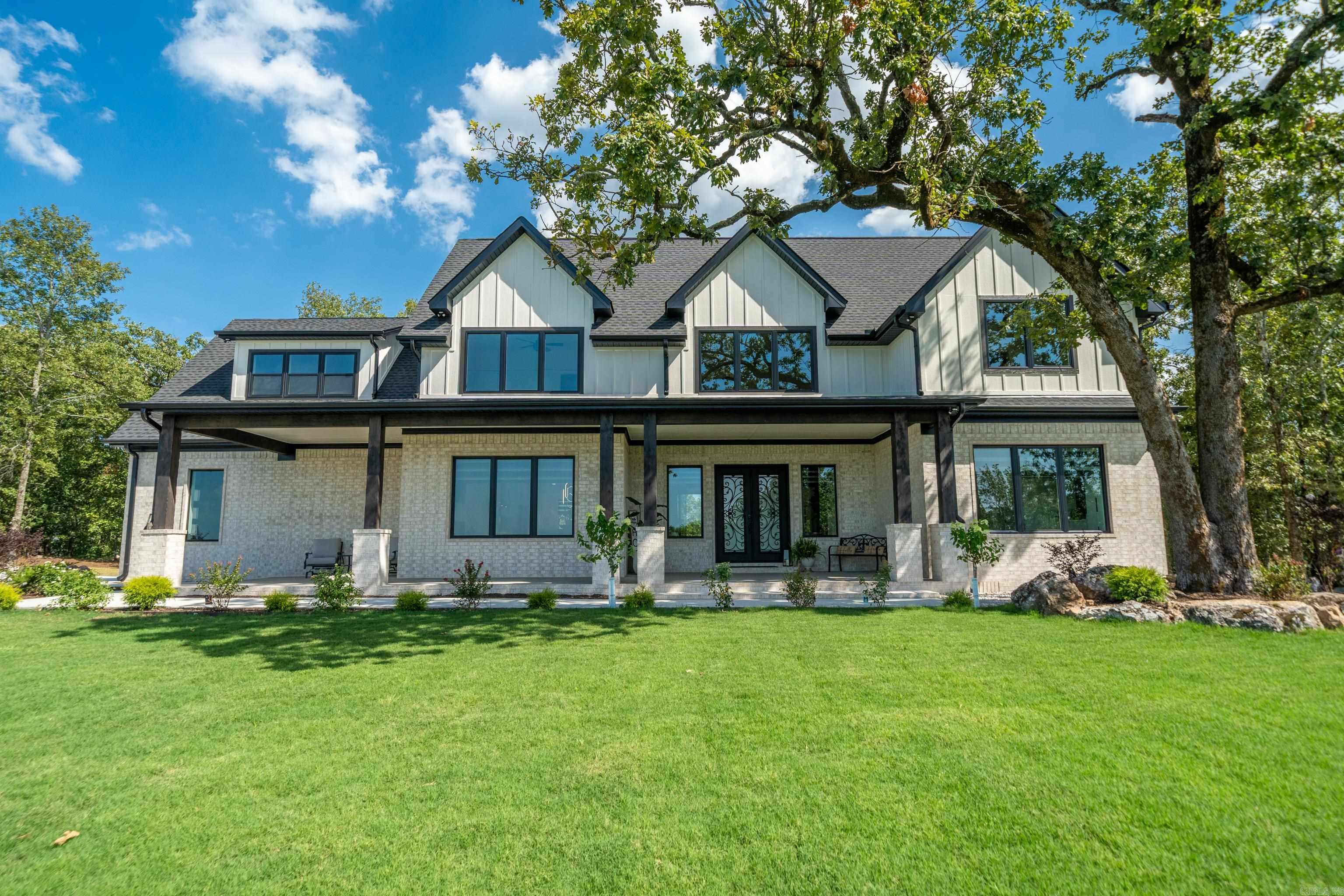 PRIVATE ARCHITECTURAL ESTATE ON NEARLY 4 ACRES WITH PANORAMIC MOUNTAIN VIEWS!! A Newly completed 4,500 sq ft custom-designed residence delivers the rare combination of architectural presence, privacy, and refined craftsmanship-set on nearly 4 wooded acres within a gated community. Constructed with high-quality materials and meticulous attention to detail, this never-occupied home offers Neo-Eclectic design, expansive mountain views, and sunset exposure from primary living areas. The open-concept interior features porcelain tile flooring, dramatic fireplaces, bold designer contrasts, and a chef-caliber kitchen anchored by black granite countertops and premium appliances. Every space was designed for both statement and functionality. The flexible layout includes 4 bedrooms, 3 full baths, 2 half baths, a game room or fifth bedroom, private office, and dual laundry areas. Outdoor living expands with a covered kitchen and grill, fire pit, gathering area privacy fence and elevated rear access-creating a seamless indoor-outdoor retreat experience. Engineered for longevity and efficiency with zoned HVAC, thermal windows, 400-amp electrical system and Starlink capability.