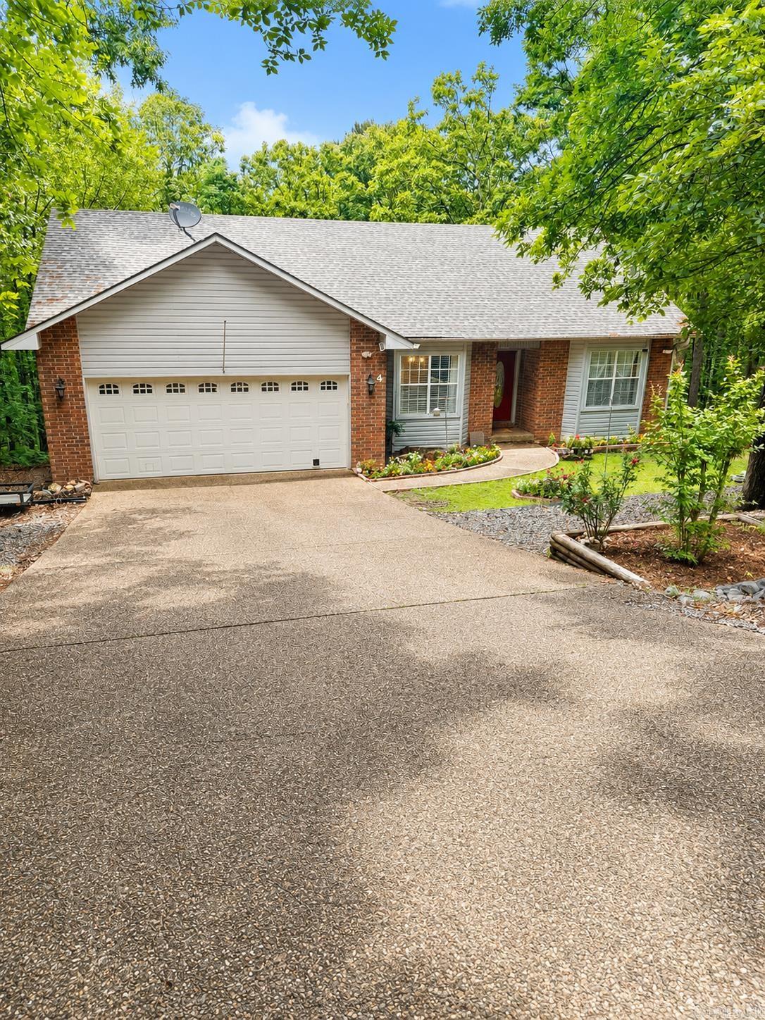 PRICED TO SELL! Tucked away in the trees of Hot Springs Village, this fully remodeled home offers the perfect blend of modern updates, flexible living space, and peaceful privacy. Renovated in 2023, this home features a bright, open-concept layout with quartz countertops, luxury vinyl plank flooring, recessed LED lighting, and thoughtful storage throughout.  The oversized primary suite feels like a private retreat with two spacious walk-in closets and direct access to the back deck — the perfect spot for morning coffee or relaxing among the wooded views. The main level also includes an additional bedroom, full bathroom, inviting living area, laundry room, and a beautifully updated kitchen designed for both everyday living and entertaining.  Downstairs opens up even more possibilities with a second living area, full bathroom, traditional bedroom, new carpet, and plumbing already in place for a future kitchenette. Whether you're searching for multi-generational living, guest quarters, a game room, home office, or potential rental income opportunity, this lower level gives you the flexibility to make it your own.  Schedule your showing today!