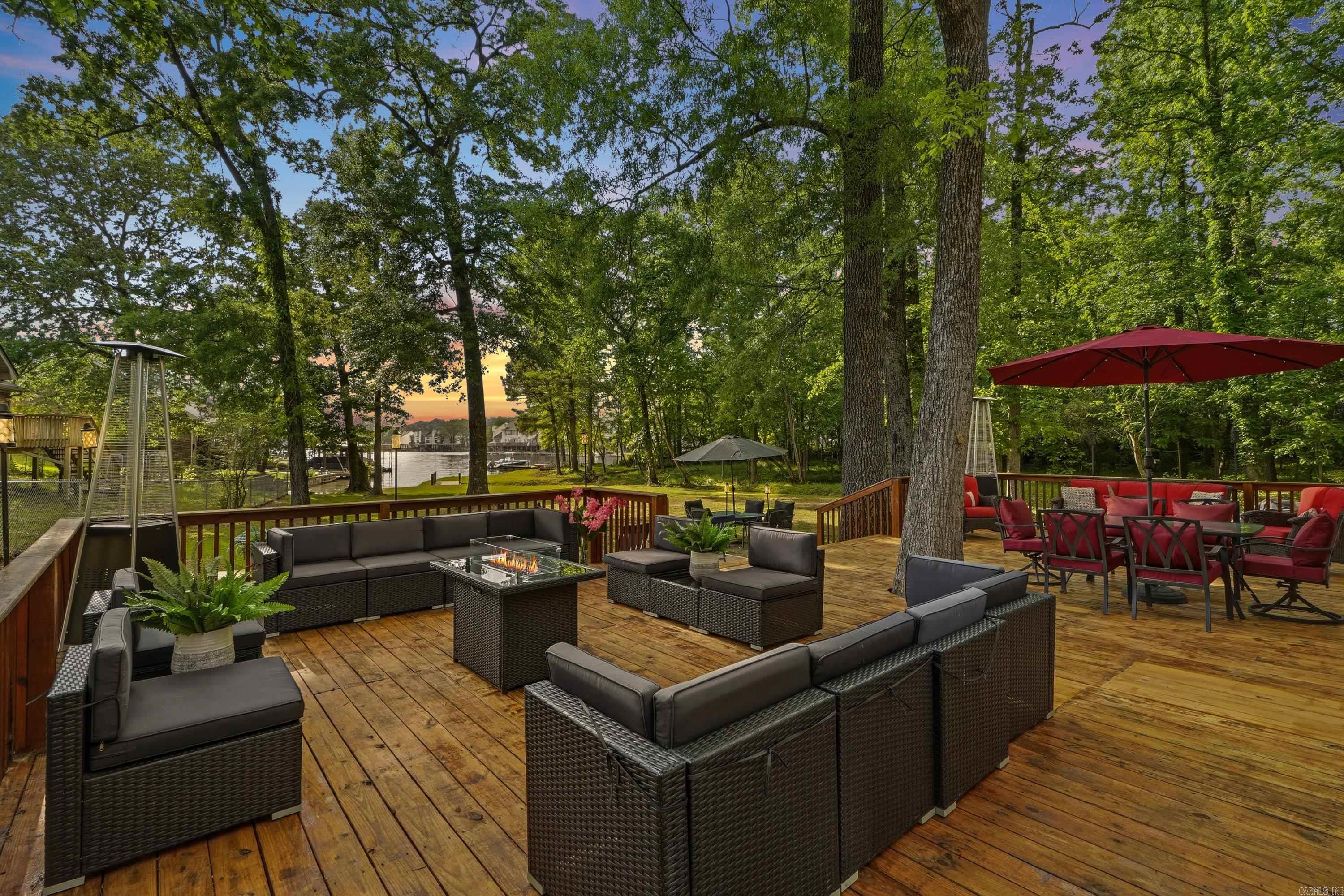 Experience luxury lakefront living on Lake Hamilton in Hot Springs, Arkansas. Completely remodeled with high-end finishes and thoughtfully designed. This stunning waterfront home offers 2,442 square feet of beautifully updated living space with four bedrooms, three and a half bathrooms, and a versatile flex room to fit your lifestyle needs. This exceptional property features two spacious primary suites, each with private en-suite bathrooms, creating the perfect setup for guests, multigenerational living, or a luxury vacation retreat. Inside, you’ll find modern finishes, an inviting layout, and spaces designed for both comfort and entertaining. Step outside to the expansive lakeside deck where family and friends can gather, relax, and enjoy breathtaking sunsets on Lake Hamilton. Whether hosting summer cookouts, sipping morning coffee, or unwinding after a day on the water, this outdoor space is made for making memories. With no HOA fees and no restrictions, this rare luxury property offers endless possibilities as a full-time residence or vacation home. Enjoy the freedom of lake living without limitations in one of Hot Springs’ most desirable waterfront locations.