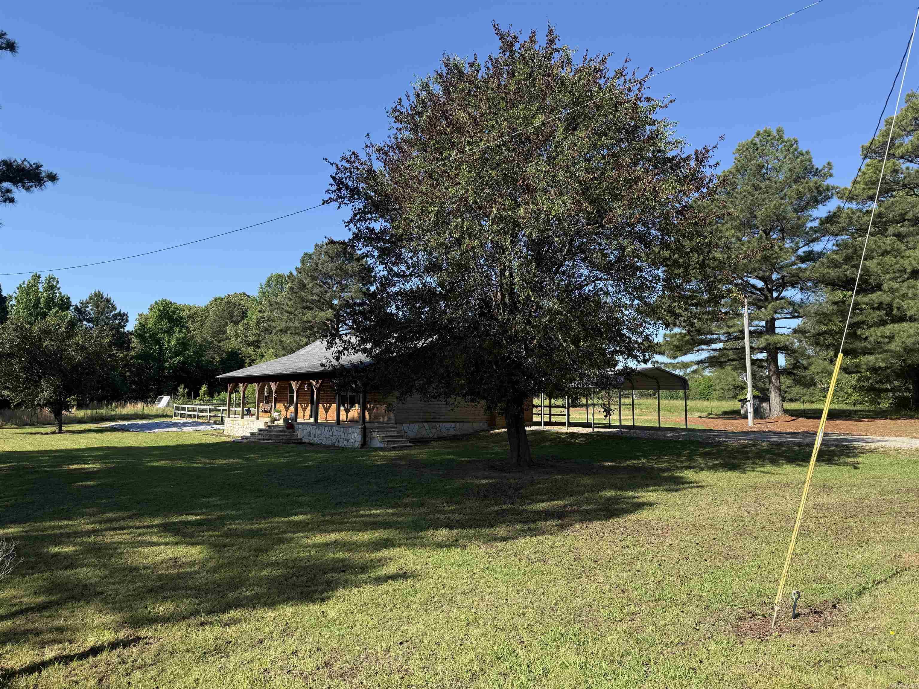 Beautiful 3-bedroom, 2-bath log style home on 5 fenced acres near Jonesboro and Brookland, just over a mile from Hwy 351. This rustic country home features pasture space for horses or livestock, a large metal shop, covered deck, and a peaceful setting close to town. Inside you’ll find an oversized living room with vaulted ceilings, knotty pine walls, laminate flooring, ceramic tile in the main areas, and carpeted bedrooms. The primary suite includes a walk-in closet and private bath with jetted tub. A great country property with charm, acreage, shop space, and a convenient location!