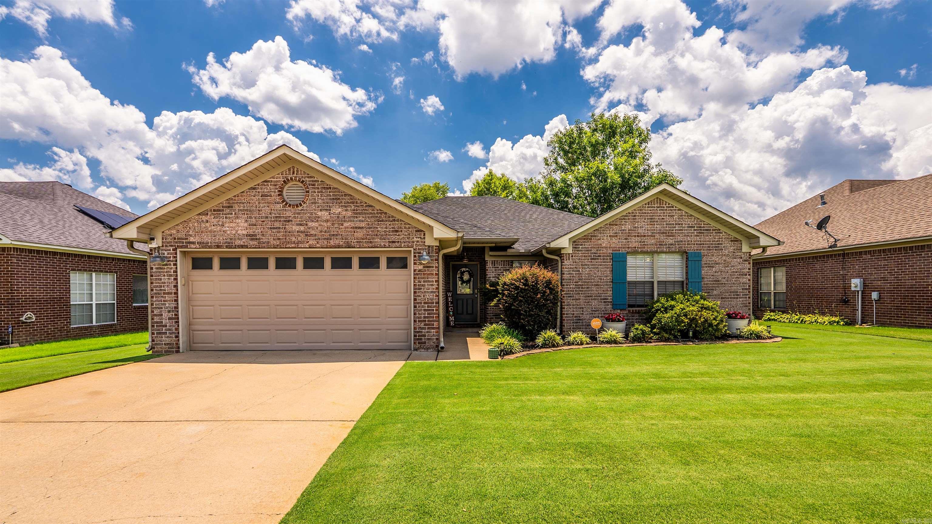 Round the corner to Ruby June, and you will feel it before you see it. This is the street where kids still ride bikes until the porch lights come on. This meticulously maintained home sits in a quiet subdivision, built for the life you actually want to live. The split floor plan gives everyone their own corner, so mornings start easy and evenings end together. The kitchen anchors it all, with warm wood cabinetry and stainless appliances, made for Sunday pancakes and the kind of dinners where everyone lingers at the table. Just off it, the living room settles in around a fireplace and built in shelving, the kind of room that pulls you in and asks you to stay a while. The primary suite offers a quiet escape of its own, with a soaking tub built for slowing down at the end of a long day. Step out back and the story keeps going. A large, flat yard, fully fenced and beautifully landscaped, becomes the place where summer happens. Wide open grass for the kids who to play and the dog who loves to run and your favorite place to host friends and family. This wonderful home is ready for its next owner and your next chapter! Don't let this be the one you let get away.