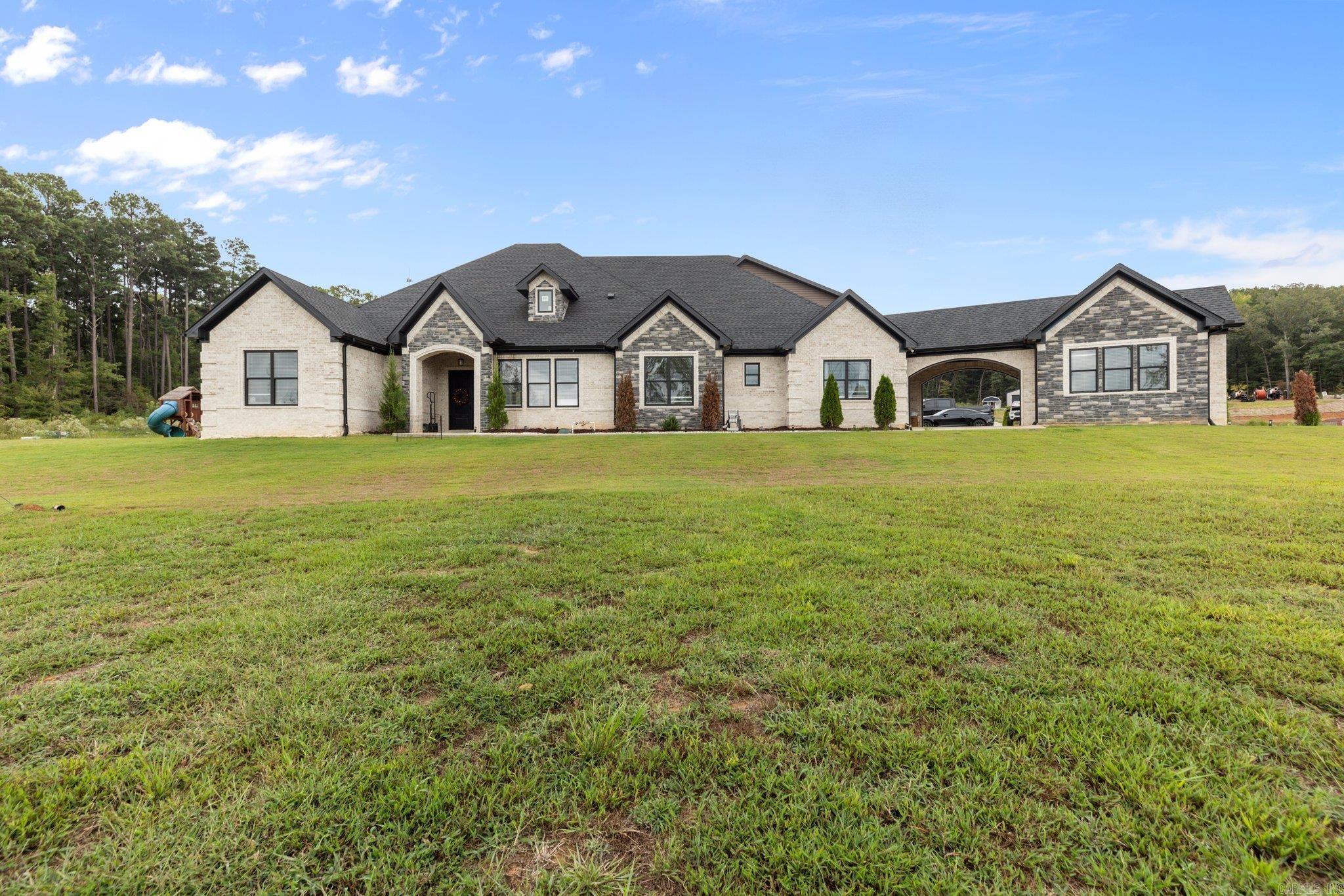 Luxurious Living on 16 Acres! Welcome to your dream home! This exquisite property features a generous 4809 sq. ft. of well-maintained living space, nestled on a 16-acre lot. This stunning residence features 5 spacious bedrooms and 4 bathrooms! The heart of the home is a beautifully designed kitchen, complete with elegant granite countertops and a spacious pantry room. A highlight of this home is the impressive entertainment options, including an entertaining room and a theater, ideal for movie nights or gatherings.  Step outside to experience your own private oasis! Enjoy sunny days by the pool, and host gatherings in your pool house, which also includes a bathroom and a convenient storage room. This home also features the perfect space for your own private gym and a 60x80 shop with 3 electric doors. The master suite features a luxurious bathroom, a walk-in closet and a saferoom! One of the guest bedrooms is conveniently located upstairs with its own full bathroom. Completing this remarkable property is a three-car garage, providing ample space for vehicles and storage.  Don’t miss this rare opportunity. Schedule your private showing today!