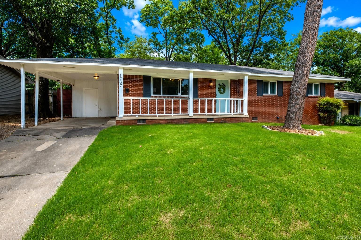 Step into timeless character with thoughtful modern updates in this beautifully refreshed 1950s home with 3 bedrooms, 2 bathrooms, & a one-car carport, this residence blends classic charm with today’s conveniences in all the right ways. Original hardwood floors add warmth & authenticity throughout, complemented by fresh interior paint and updated lighting that create a bright, inviting atmosphere. The kitchen has been tastefully refreshed with newer painted cabinetry, updated hardware, and a modern sink and faucet. Both bathrooms strike an ideal balance, preserving desirable mid-century modern elements while incorporating stylish updates for everyday comfort. Recent improvements provide added peace of mind, including energy-efficient windows, a newer roof, and an upgraded HVAC system with a smart thermostat. Updated door hardware, modern rocker light switches, and refreshed exterior trim paint contribute to the home’s polished, move-in-ready feel. Step outside to a spacious, fenced backyard, perfect for entertaining, pets, or future expansion. Enjoy enhanced privacy with a newer installed 8-foot stained cedar fence and attractive curb appeal. Agents please see remarks.
