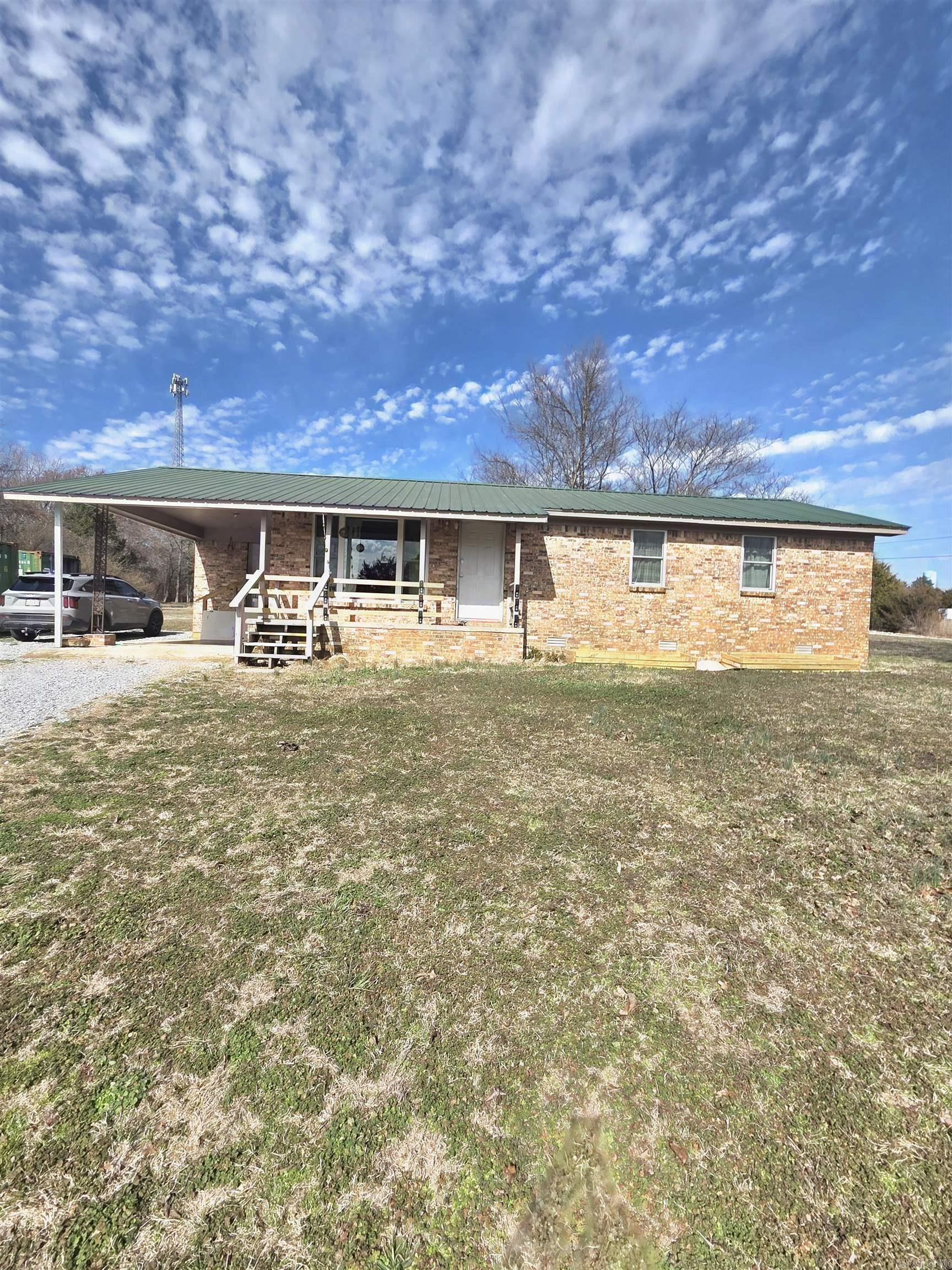 This 3 bedroom brick home has been totally renovated with new flooring in every room. It has dual mini-split systems that run 5 mini-splits. The foundation, cross beams and sub-flooring have been shored up with some new sub-flooring. New windows throughout and 3 new exterior doors on order. New propane tank (rental) with new lines run to appliance. Fresh paint in every room. New range and refrigerator. Is plumbed for on demand hot water heater. The railings on the front porch are removable for easy furniture and appliance loading and unloading. This is like  new home!! Level lot almost on acre with raised garden beds already in place. New survey, back of property cleared to make for easy fence building! On a corner lot. All of this for $195,000.