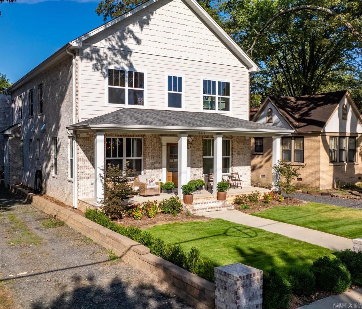 Newer Heights construction with fantastic layout!  Wonderful windows allow tons of natural light into this two year old home. Tall ceilings, pretty hardwoods, & wonderful finishes are all throughout. Off of the alley in the back of the house is entry into a large two car garage and space for four more cars to park!  Wonderful back porch with fireplace & vaulted wood ceiling with wood beams!  Just beautiful! (AND hookups already there to easily add an outdoor kitchen!)  Covered front porch allows a fun place to watch all the fun happening in the vibrant Heights neighborhood!  The large marble kitchen island has bar seating and across is a bar/storage area with pretty green paint. Large gas stove. The primary bed is on the main level with a big walk in closet and lovely bath with double vanity. There is a formal dining room with great looking wallpaper, a small desk space and gorgeous half bath also downstairs. Upstairs are 3 bedrooms, one en-suite and 2 beds that share a jack & jill bath, all with walk in closets! There is a second laundry upstairs. Also, there is a 5th bedroom and bathroom (wired & plumbed just needs finish out - seller has a quote) if someone wants a 5th bedroom!