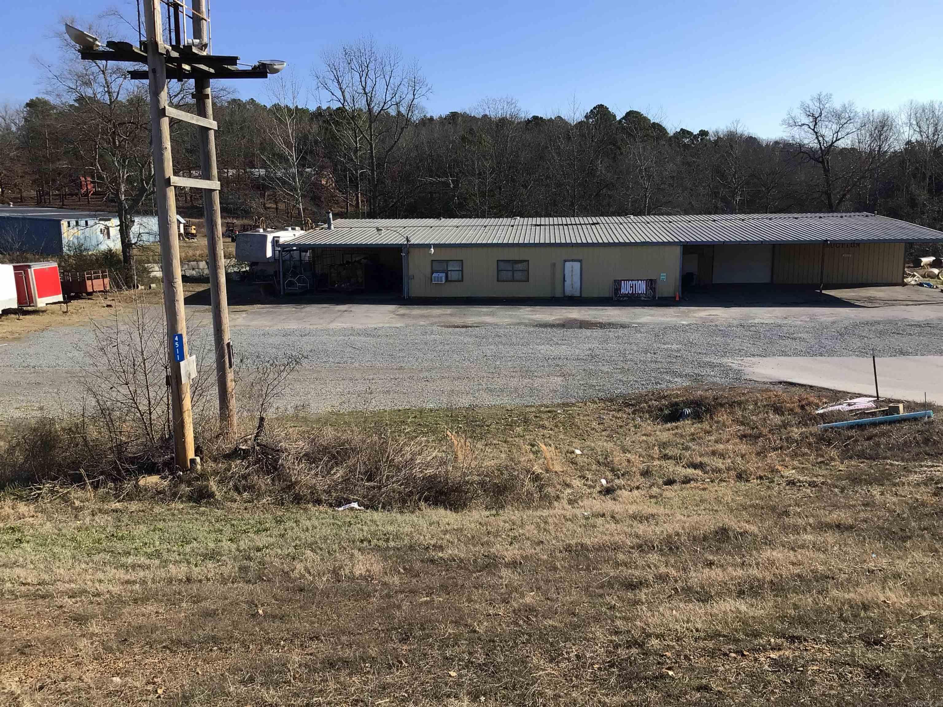 Prime Commercial Opportunity – Highway 65, Clinton  Positioned along highly visible Highway 65, this versatile commercial property offers exceptional potential for a wide range of business uses. The property features a spacious 7,572 square foot metal building, currently operating as an auction barn, making it well-suited for retail, storage, events, agricultural operations, or redevelopment.  Situated on approximately 8.56 acres (more or less), the property provides ample room for expansion, parking, or additional structures. Its generous acreage combined with highway frontage ensures excellent accessibility and exposure.  Property Highlights:  7,572 sq ft metal building  8.56 acres ± of land  Direct frontage on Highway 65  Currently configured as an auction barn  Utilities in place: city water, electricity, sewer, and natural gas  Plenty of open space for growth or customization  Located just a short drive from Greers Ferry Lake, this property benefits from both local traffic and visitors to the area, adding to its commercial appeal.  Whether you're expanding your business, investing in commercial real estate, or seeking a multi-use property with room to grow, this location offer