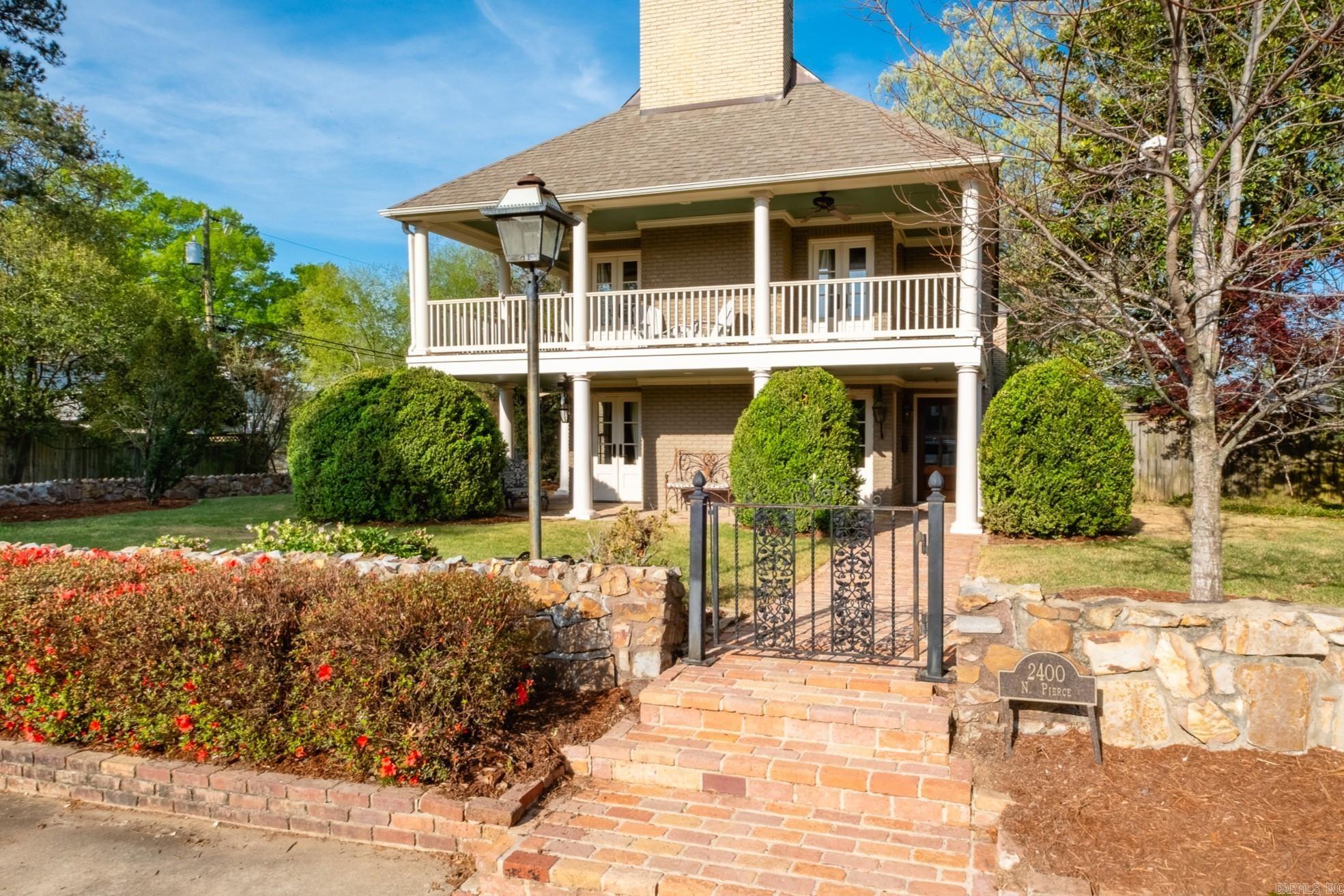 Commanding a quarter-acre corner lot, this Heights home masterfully blends historic charm and modern luxury. A brick pathway leads to a gracious two-story covered porch framed by classic columns, beadboard ceilings, and gas lanterns. Inside, the layout easily accomodates busy lifestyles and gatherings of family and friends. The formal living room boasts a sleek marble fireplace, while the spacious back den warms up with rich hardwoods and a classic brick hearth. The chef's kitchen is the true heart of the home, equipped with a professional Wolf gas range, custom white cabinetry, granite countertops, and a seamless flow into formal and casual dining spaces. Upstairs you'll find four bedrooms highlighted by a primary suite retreat complete with its own romantic fireplace and private balcony. Incredible bonus spaces elevate the property even further, including a bright hobby room with built-in workspaces and an adjacent laundry room with an adjoining full bathroom. The third-floor features a game room and a climate-controlled storage room. From the plantation shutters to the gleaming hardwoods, every inch of this home is designed for stylish, comfortable Heights living.