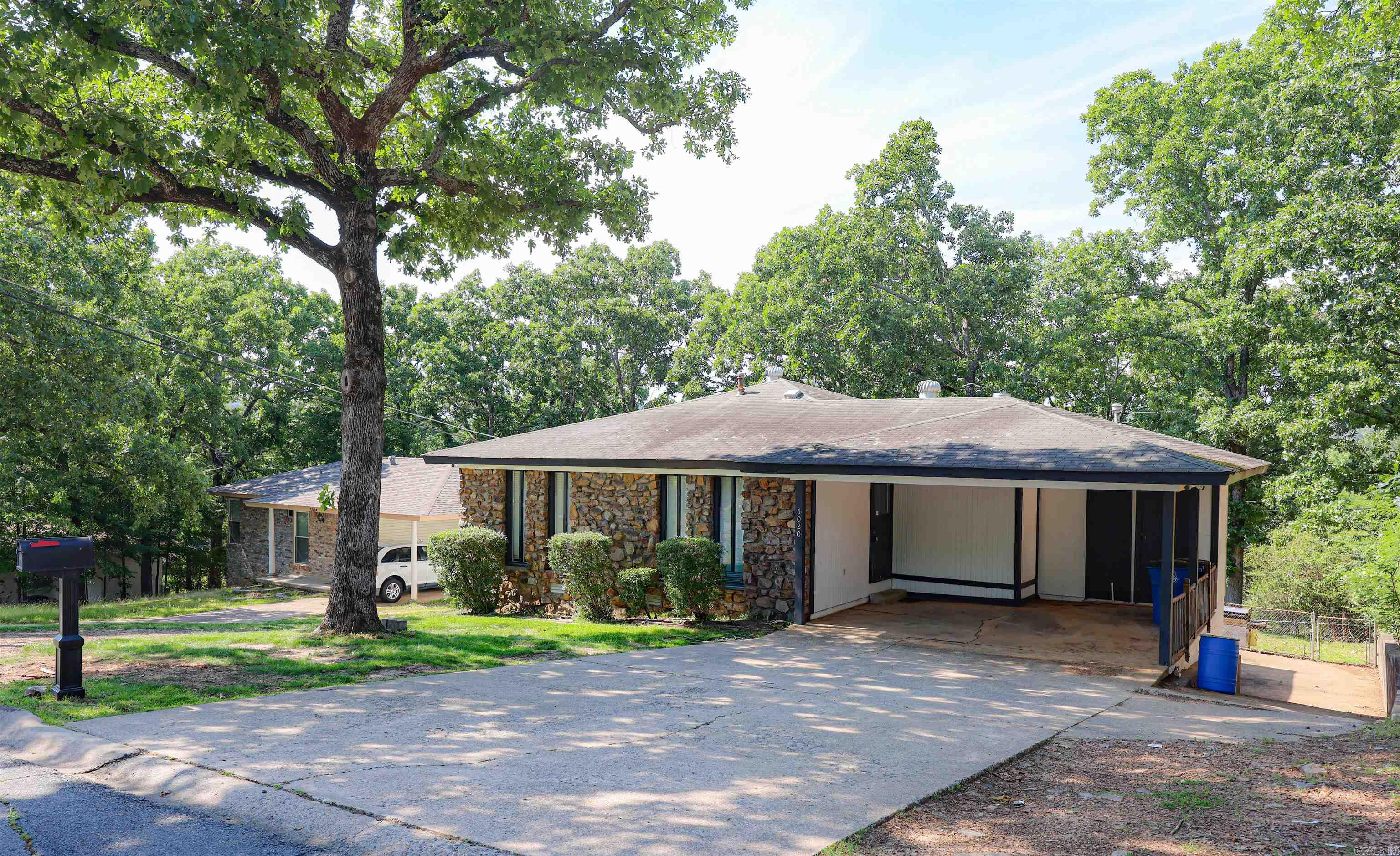 Nice 3/2 home with carport and lower level garage at rear entry of the home. Separate living/den. Split floorplan. Granite Countertops. Close proximity to Burns Park and I-40.   Property being SOLD AS-IS. No repairs.  Would be a great rental opportunity or first time homebuyer   Agents please see agent remarks.