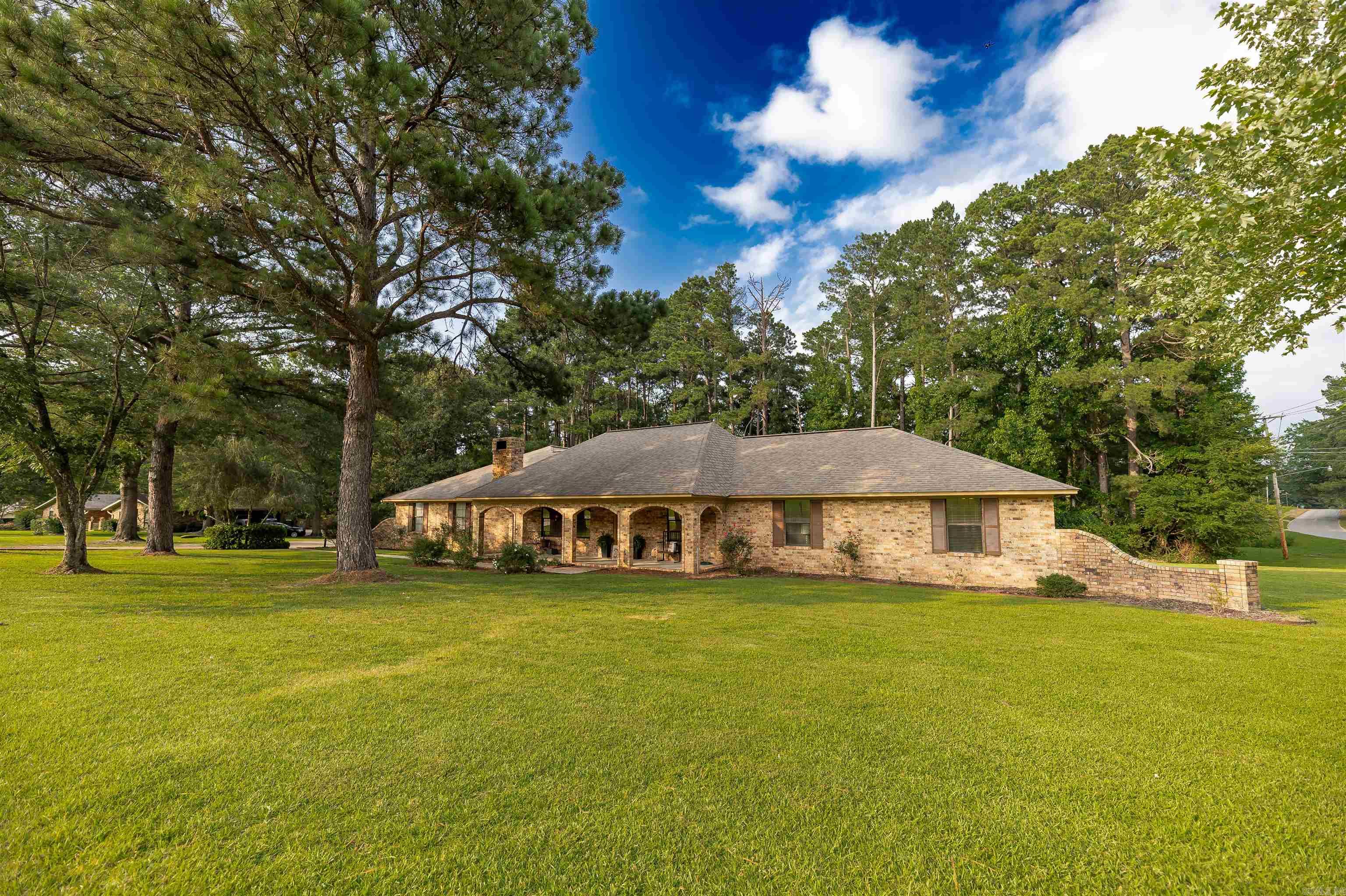 Nestled on a beautiful corner lot of over an acre in Magnolia’s desirable Forest Place subdivision, this move-in ready home offers room to spread out both inside and out.  The main home features 4 bedrooms and 3 full bathrooms, including two spacious primary suites, making it ideal for multi-generational living, long-term guests, or simply giving everyone a little extra privacy. The thoughtful floor plan offers comfortable living spaces with plenty of room to gather and entertain.  Step outside and you’ll find your own private retreat with an in-ground pool, a fully fenced backyard, and a convenient full bathroom located in the garage.  Whether you need extra garage space for vehicles, hobbies, a workshop, or storage, the rare 4-car garage offers endless possibilities. From the oversized corner lot to the backyard oasis, every inch of this property was designed to be enjoyed.
