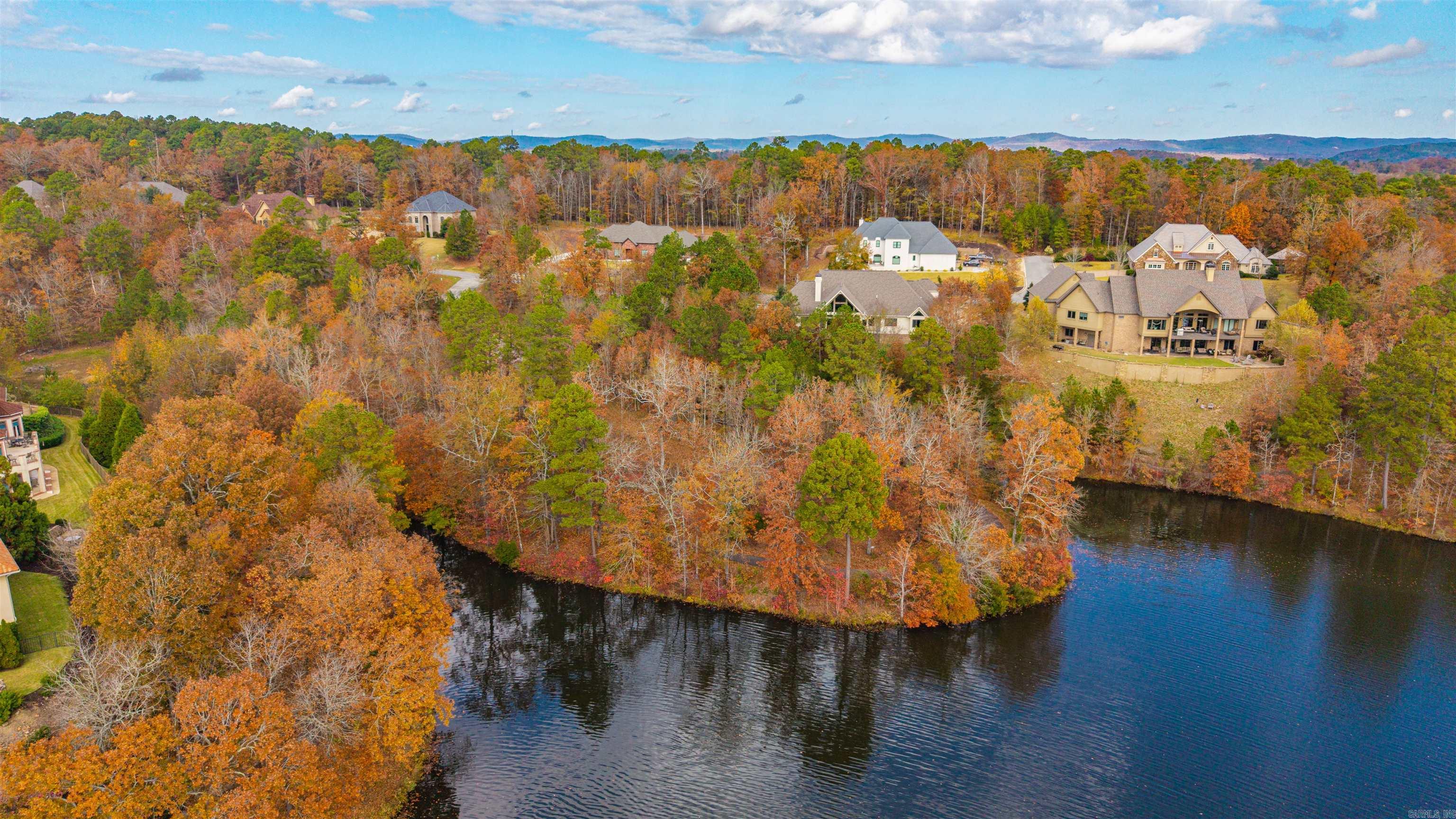 Scenic Lakefront Peninsula Lot in Gated Red Oak Ridge! Discover one of the most desirable home sites in the beautiful private community of Red Oak Ridge. This mostly level, custom home lot sits on a peaceful peninsula surrounded by natural beauty and stunning lake views. Enjoy miles of scenic walking paths that wrap around the lot, two fully stocked fishing lakes, and a sparkling community pool. Red Oak Ridge offers the perfect blend of nature and luxury living, with added conveniences like a community boat parking area right next to the boat launch. Build your dream home and experience lakefront living at its finest—peaceful, private, and perfectly positioned for enjoying the best of Hot Springs!
