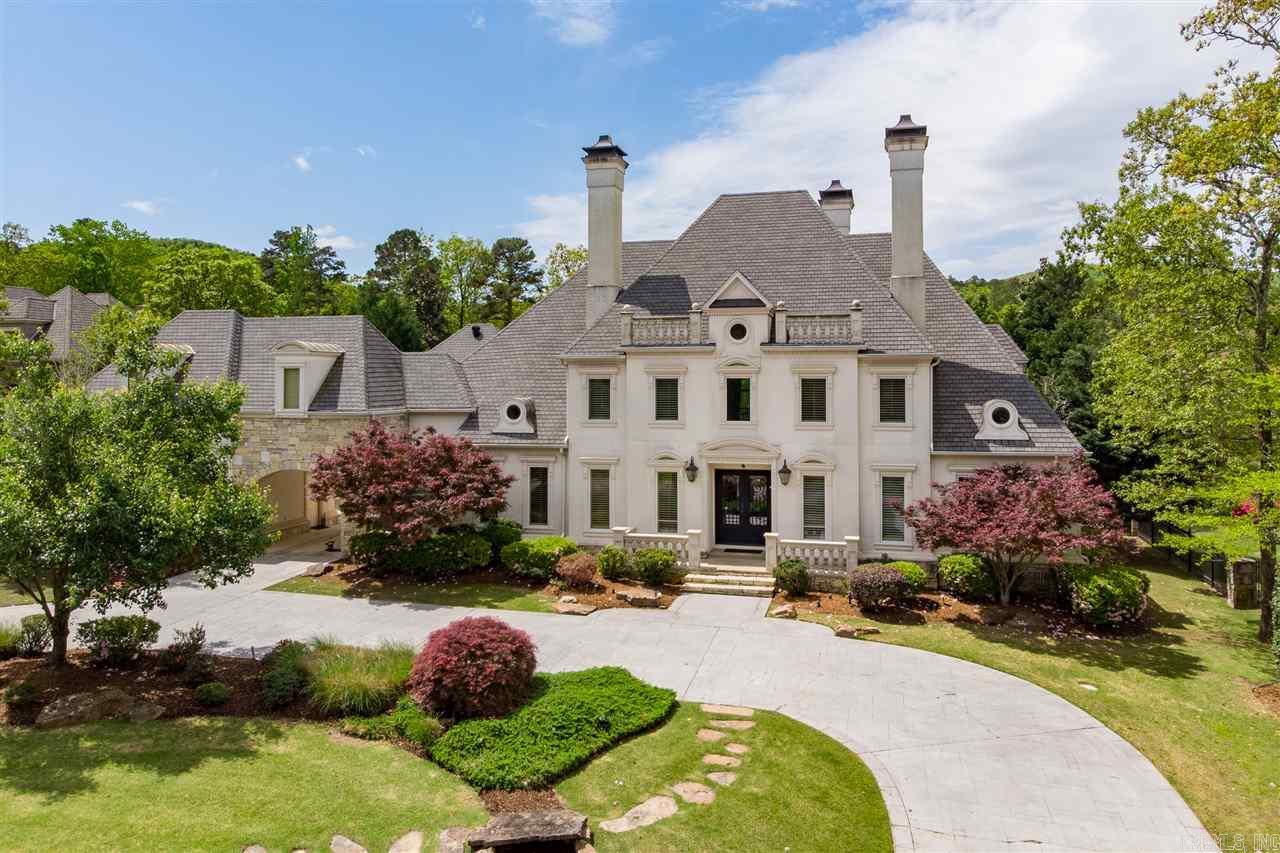 Stunning Estate in gated community.  This beautiful home backs to a creek, level yard & has a resort style pool with fp.  Two story entry open to dining rm & handsome library w/fp.  Grand living rm with fp & two story windows.  Open kitchen to dining area & Hearth Room.  Large laundry rm.  Master bedroom & guest bedroom on main level.  Upstairs has large room with pool table, tv, & game room.  Plus separate karaoke room with bar.  Theater room with screen & seats.  Three en-suite bedrooms.  Come see!
