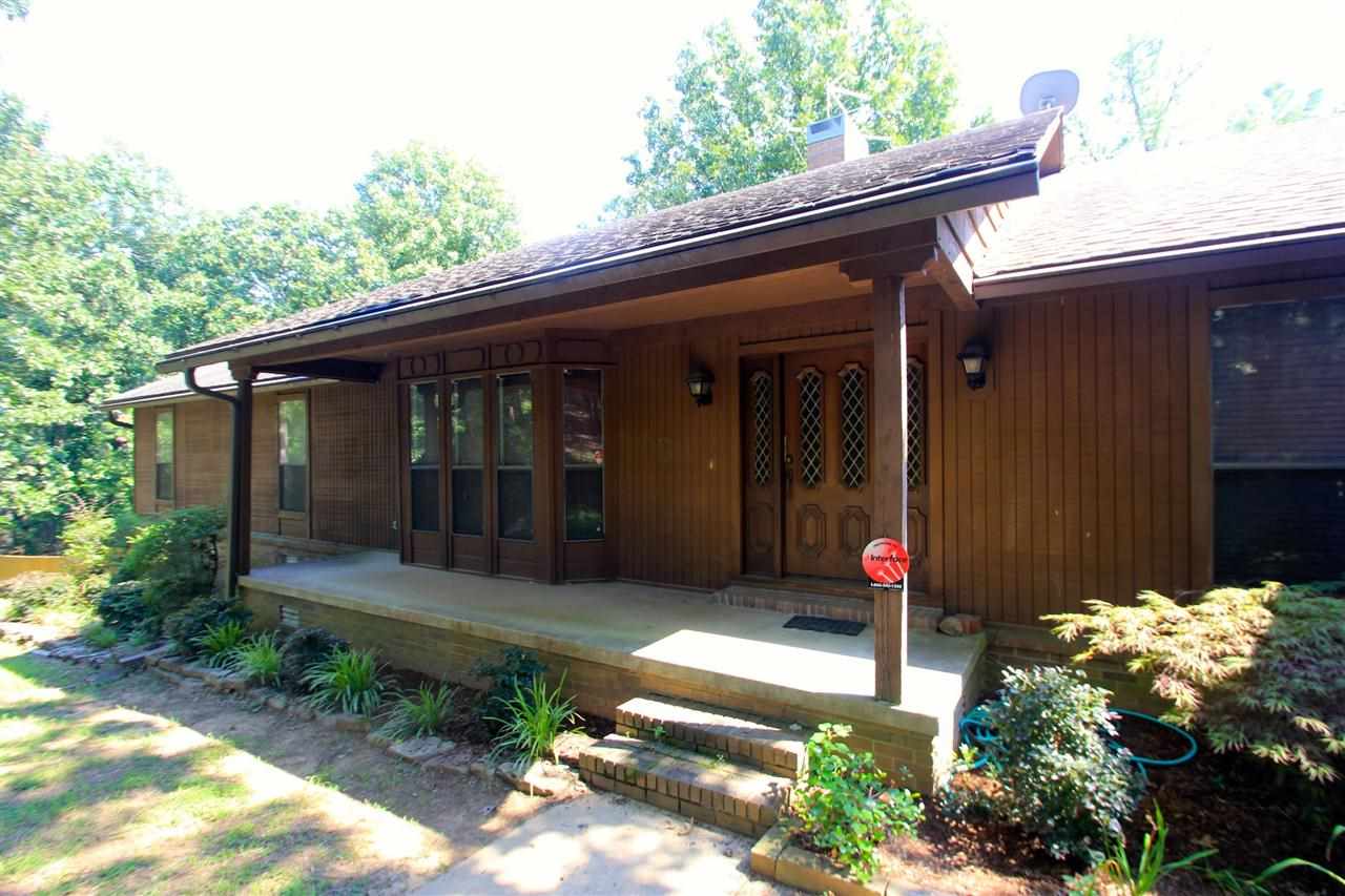 Wonderful home in a peaceful setting on 1.2 acre. Storage space galore in this meticulously kept 3 bdrm,2 ba home. Large LR w/2 sitting areas, high ceilings & built-ins. Kitchen is large w/ lots of cabinet & counter space. Bedrooms are good size & have walk-in closets. Heat/air, carpet, kit. appliances, bathroom tile & commodes all 6-7 yrs old. Hwh new in 2014.  Full finished basement/gameroom (not in sf). Built in generator hookup. Screened in porch & deck overlook woods. Leaf Guard gutters. A unique find!