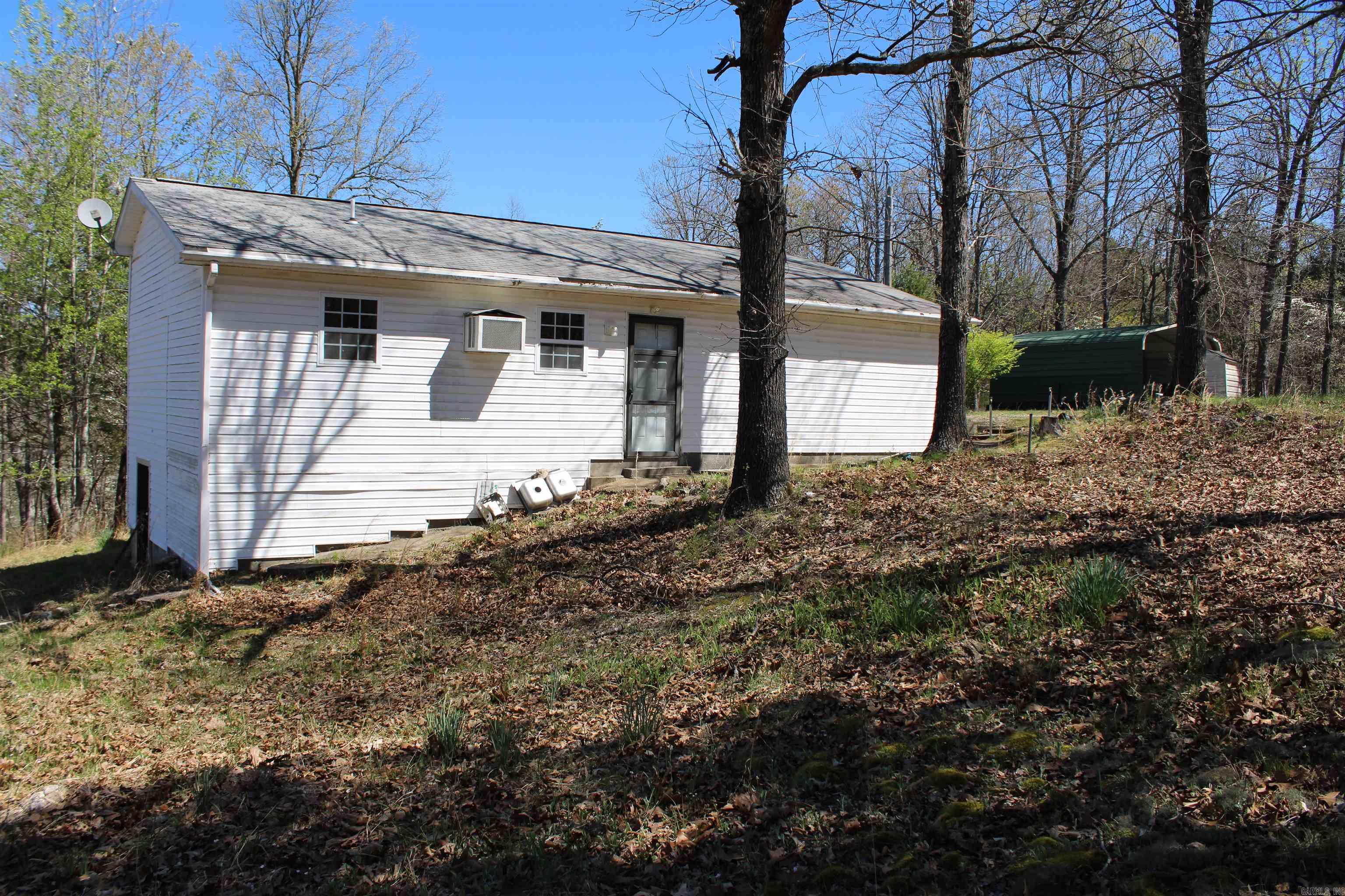 MINUTES FROM LAKE NORFORK ACCESS! This amazing property is sitting at the end of a dead-end road and touches the government strip! Located minutes from town and unrestricted! You will love all of the beautiful fruit trees and gorgeous dog wood trees.  Featuring two bedrooms, two full baths, sunroom, 8x8 green house, and a detached carport. Large Walk-in cinderblock crawl space with Water heater and well pressure tank, plus extra storage space.  Home is waiting for you to come show it some love and bring it back to life! Property is sold as is.