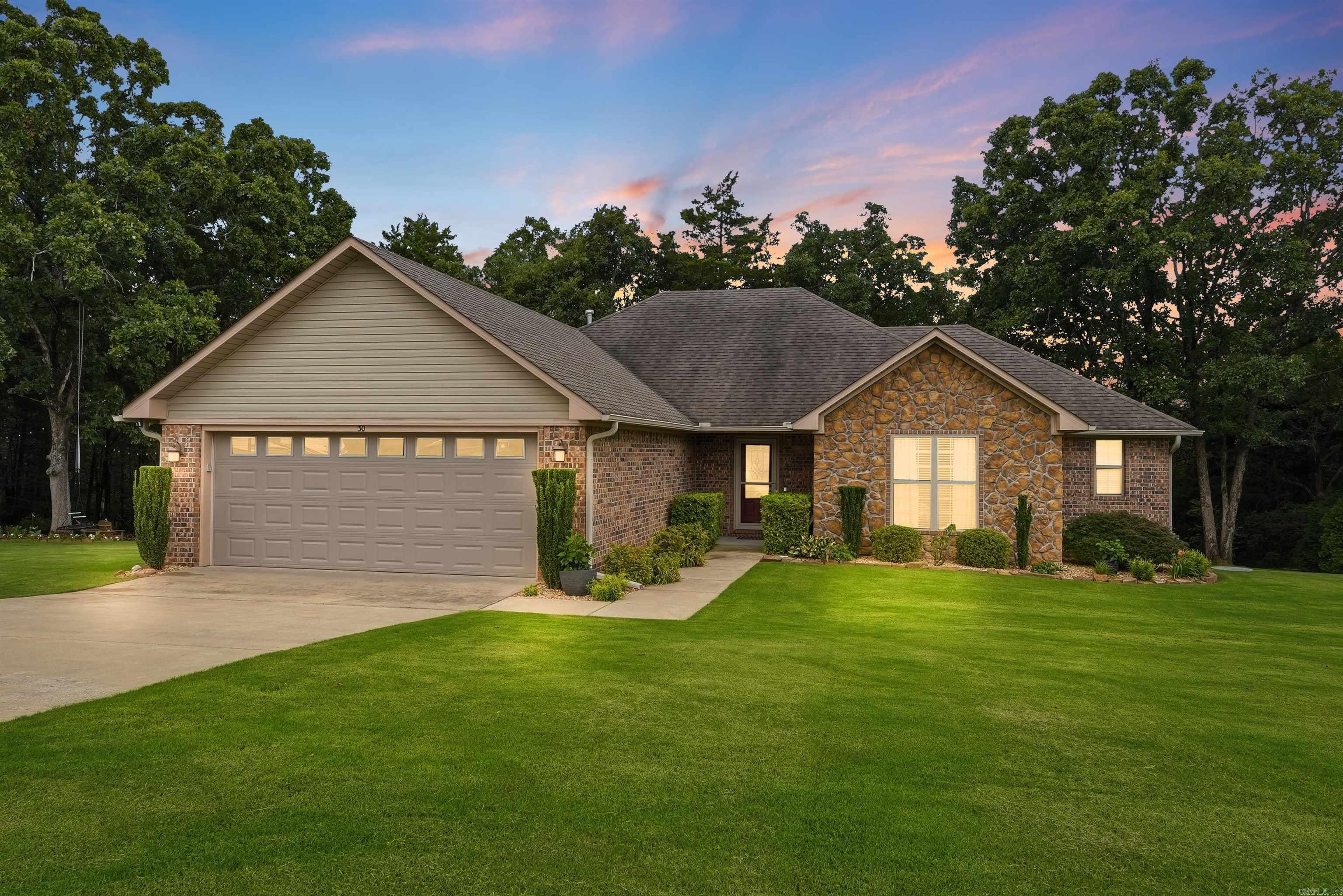 Some homes check the boxes. This one creates memories.  Tucked away at the end of a quiet neighborhood, this beautiful 3-bedroom, 2-bath home offers something that’s becoming harder and harder to find: peace, privacy, and a place you’ll genuinely look forward to coming home to every day. Situated on a meticulously maintained .54-acre lot, this property was built around the experience of homeownership. One of the most beautiful yards you’ll find features lush, soft grass, mature trees, and a stunning wooded backdrop, all supported by a custom 10-zone WiFi-controlled sprinkler system. As evening arrives, string lights woven throughout the trees and across the massive custom deck create a setting that feels straight out of a magazine. Whether entertaining guests or enjoying a quiet sunset, this outdoor space is truly special. The primary closet doubles as a large storm shelter/safe room with space for family, friends, and neighbors when needed. The garage offers custom built-in storage for tools, hobbies, and organization. If you’ve been searching for more than just another house, this is a home designed to be enjoyed, appreciated, and lived in every single day.