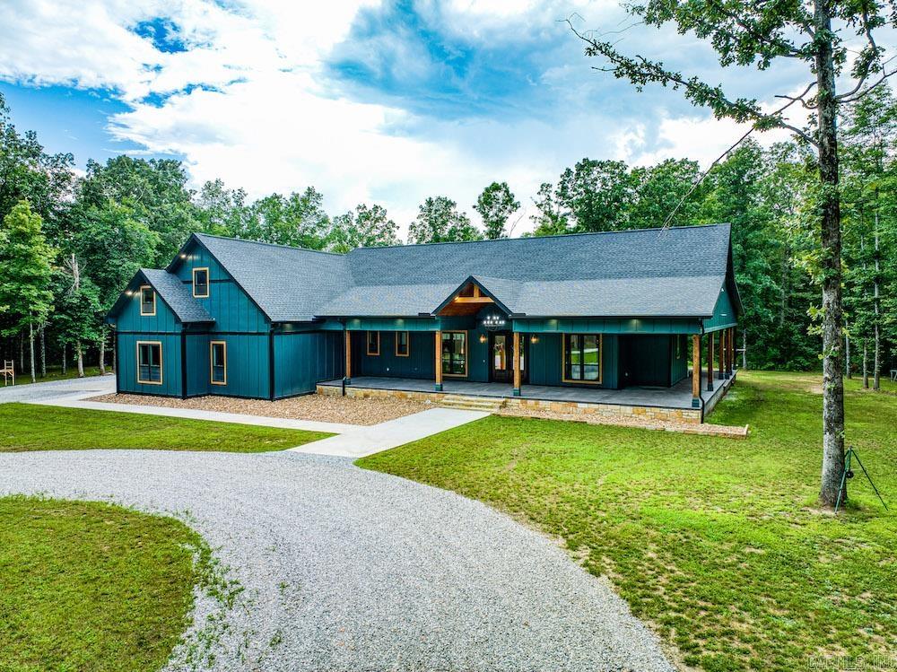 A stunning 4,621 sq ft custom home just minutes from downtown Mountain View, AR, nestled on over 7 private acres. This 5-bed, 3.5-bath estate features high-end finishes throughout, including vaulted ceilings, wide plank vinyl flooring, and a rock fireplace. The gourmet kitchen boasts Thor appliances, quartz countertops, and a massive island, while the butler’s pantry and mudroom add function and style. Enjoy over 5,000 sq ft of covered porches, an outdoor kitchen, firepit, and a 4-car garage with bonus workout space. The luxurious master suite features 22’ ceilings, a fireplace, spa-like bath, and a spacious walk-in closet. Additional highlights include a game room, home office, 6-zoned HVAC, security system, whole-home water treatment, and generator hook-up. Located just 1.5 miles from White River public access, this exceptional property combines luxury, space, and proximity to town—an incredibly rare find. Call today to schedule your private tour.