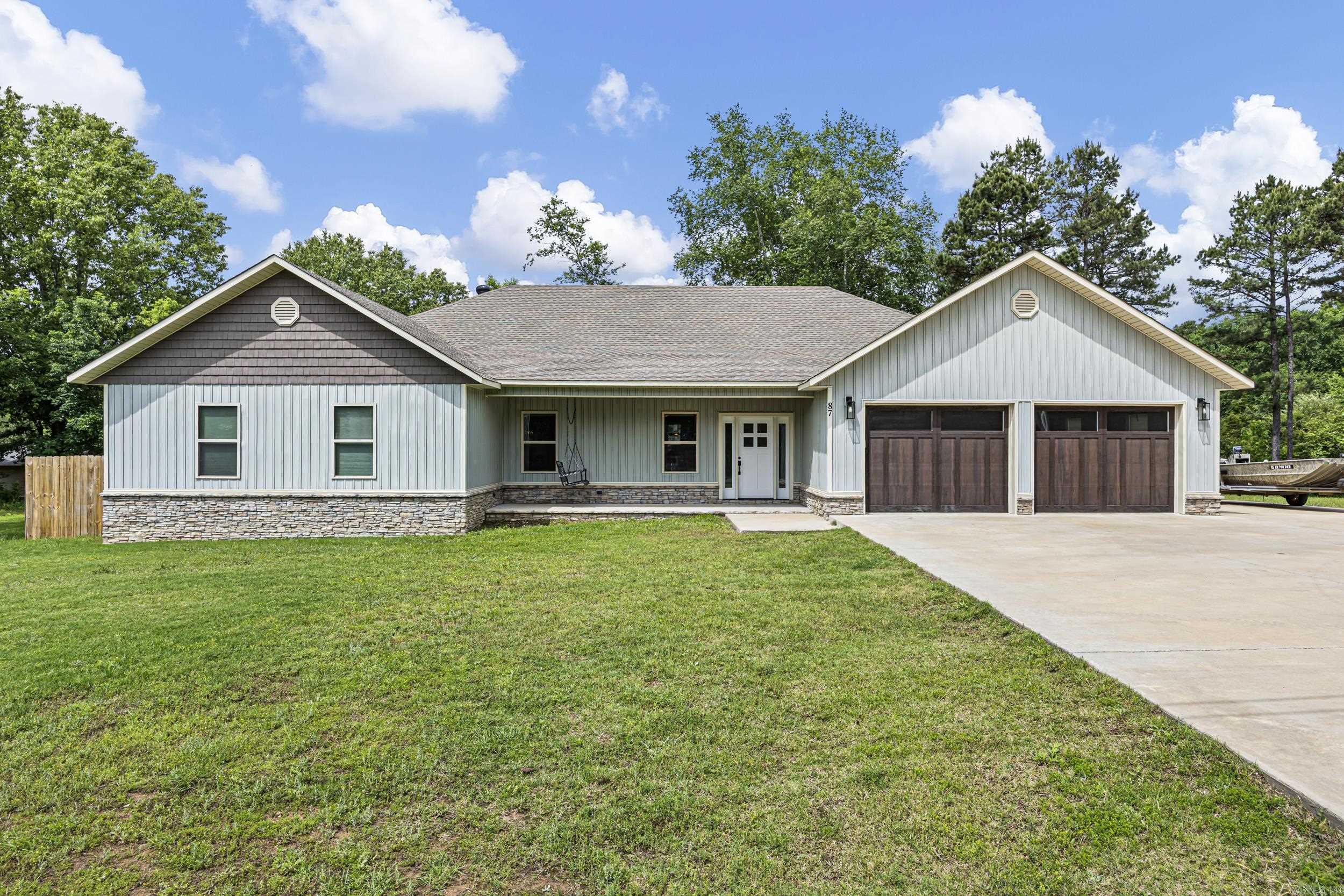 Built in 2023, this 4-bedroom 2-bath home is ideally located next to the Russellville Country Club and sits on just under a acre. the open great room features vaulted ceilings, creating a bright and welcoming space for everyday living and entertaining. The primary suite offers a large walk-in closet with laundry hookups and a spa-inspired en-suite bath featuring a custom tile shower with rain shower head and a relaxing jet tub. Additional bedrooms are generously sized offering flexibility for family, guests, or a home office. Enjoy the privacy of a spacious lot with the convenience of nearby golf, dining, and town amenities.