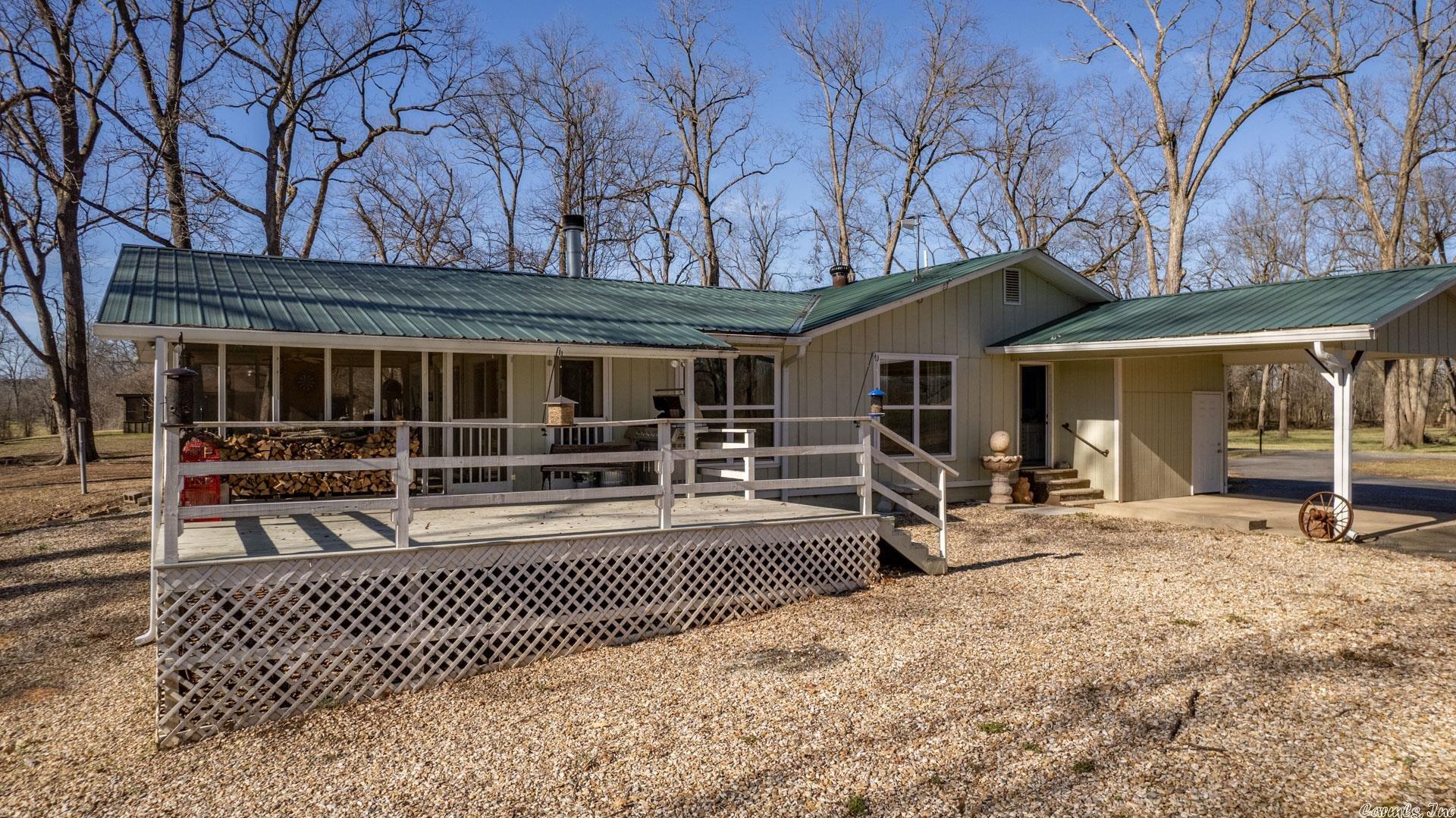 This is a must see!   If your looking to get away from everything, this is your spot. This beautiful home updated in 2019 on 2 acres featuring 2 bed 2 bath sits directly on the Arkansas river with 400ft of riverfront! With amazing views of the river from the back deck, living room, and master bedroom. Equipped with a mosquito barrier spray system, cellular boost tower and tankless water heater. It also boasts a 1400 sqft insulated shop with an automatic garage door. The washer and dryer convey with the property. This is a duck or deer hunters paradise. Boat access 1 mile from house at merry lock and dam. The shop also has a full bath!