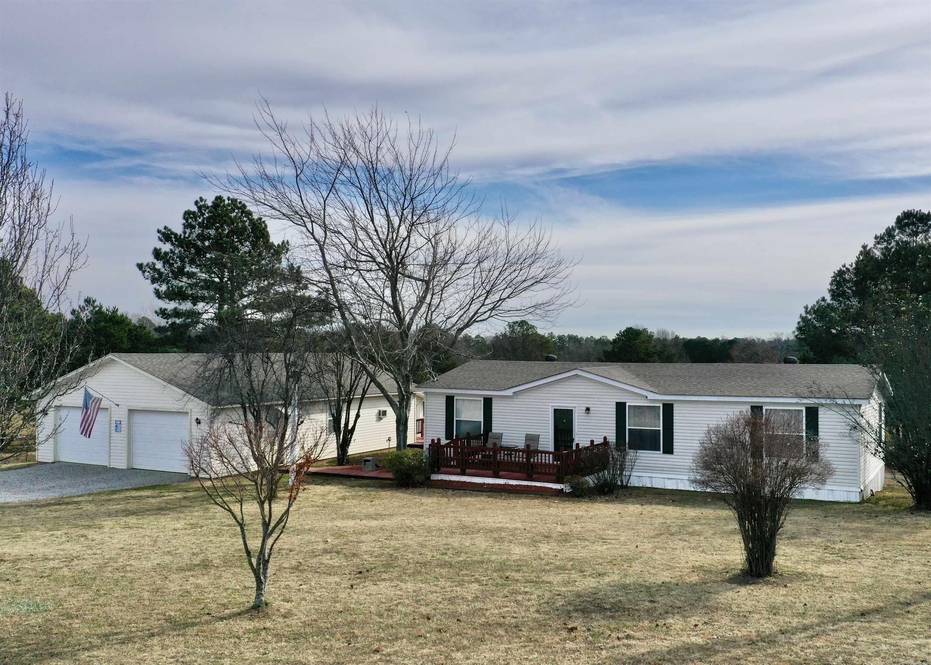 Extremely well maintained 3 bedroom, 2 bath mobile home on 2 acres. Convenient to the Little Red River and Greers Ferry Lake. This property boasts a 30x40 shop with automatic doors and man cave area as well as a separate storage building with an automatic door. The decking around the home provides multiple options for outdoor seating and entertaining. All electric, new roof on the home, shop and building in 2021. New fixtures and LED lighting in 2020 as well as clearing on the back of the property. Take a look!