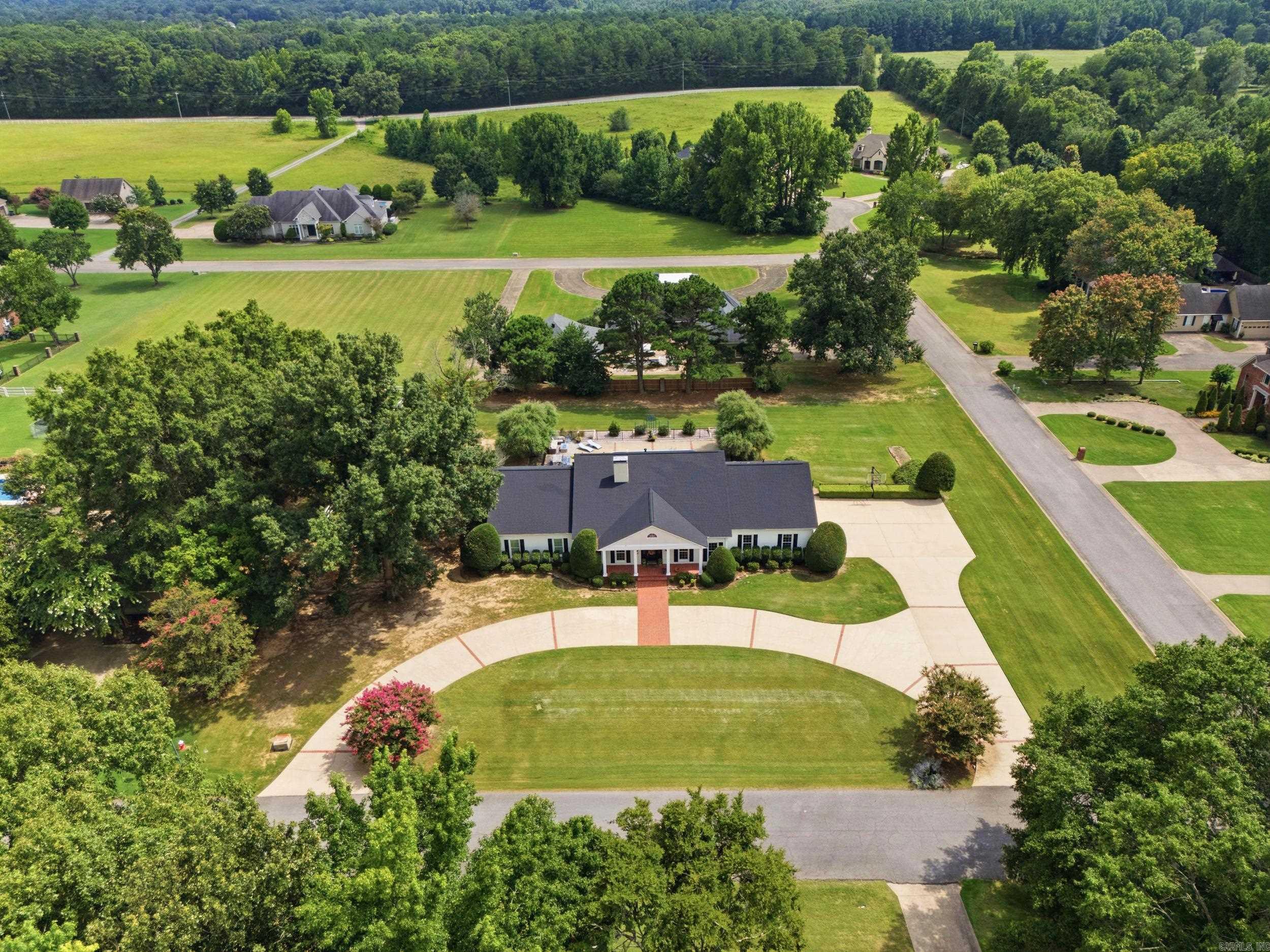 Nestled on a beautifully landscaped 1.16-acre corner lot in the highly desirable Searcy Country Club area, this timeless home offers the perfect blend of classic charm, spacious living and modern convenience. Featuring 4 BR and 4.5 BA, this exceptional property is thoughtfully designed for both comfortable everyday living and entertaining. Guests are welcomed in the foyer, highlighted by beautiful hardwood flooring, which continues into the formal dining room and throughout the spacious open living, kitchen and dining area which provides the perfect setting with large windows that overlook the pool area. The large primary suite serves as a private retreat, offering generous space and comfort. Each of the 3 bedrooms have their own bath, with two of them being on the second floor. Upstairs, you will also find a huge game room and a bonus area as well. Custom closets throughout the home and abundant storage spaces ensure everything has its place. Step outside to your own backyard oasis featuring an inground saltwater swimming pool, ideal for relaxing and enjoying Arkansas summers. Additional highlights include a two-car garage plus golf cart. Agents, see remarks!