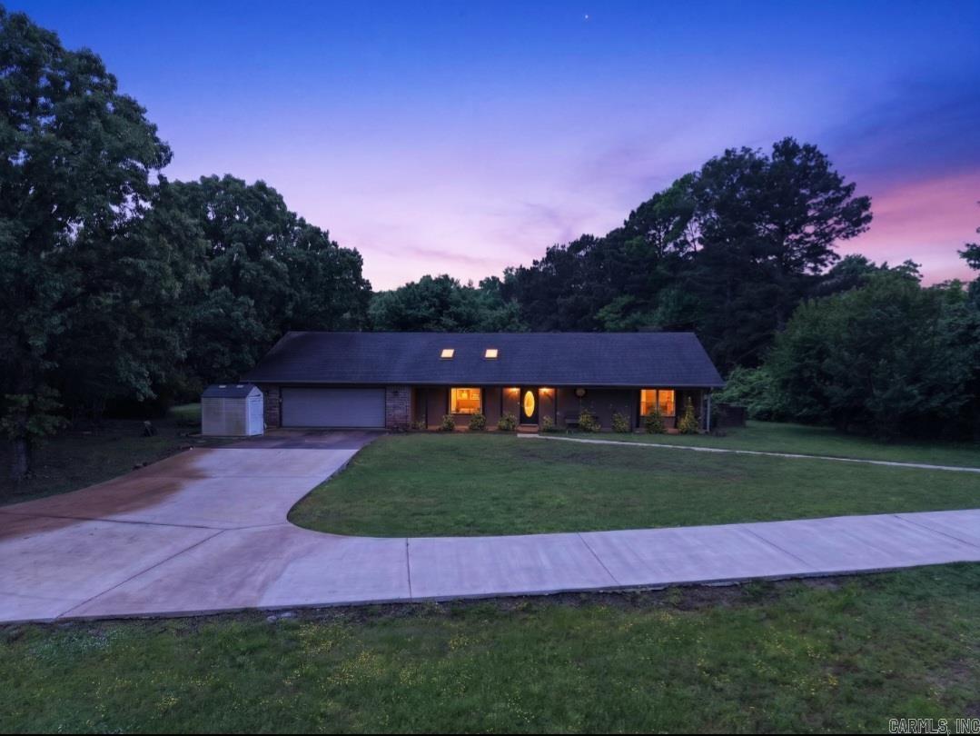 Situated on 1.5 acres in a rural cul-de-sac, this property offers privacy with convenient access to Cabot, Little Rock, and Little Rock Air Force Base. Inside you'll find an open kitchen, two living areas, and a large sunroom with attached bath that provides a flexible bonus space. Recent updates include Energy Star windows, tankless water heater, updated countertops and electric fireplace. Enjoy the screened in porch and wooded setting. Hot tub, refrigerator, washer, and dryer will convey. RD financing eligible for qualified buyers. Disclosure -Photo display of twilight has been reimagined.