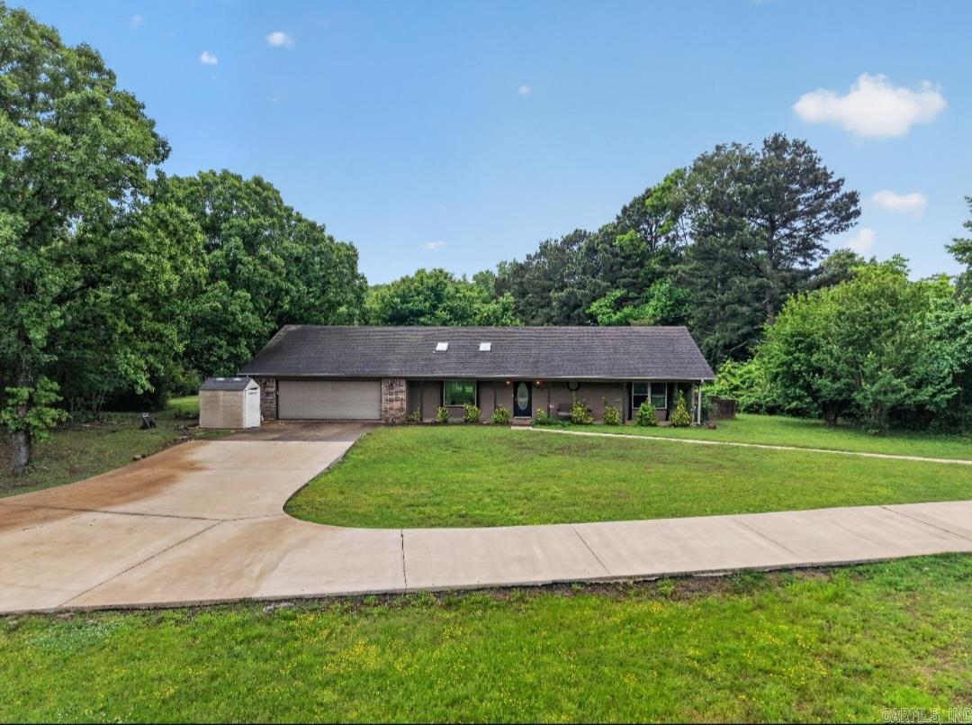 Situated on 1.5 acres in a rural cul-de-sac, this property offers privacy with convenient access to Cabot, Little Rock, and Little Rock Air Force Base. Inside you'll find an open kitchen, two living areas, and a large sunroom with attached bath that provides a flexible bonus space. Recent updates include Energy Star windows, tankless water heater, updated countertops and electric fireplace. Enjoy the screened in porch and wooded setting. Hot tub, refrigerator, washer, and dryer will convey. RD financing eligible for qualified buyers. Disclosure -Photo display of twilight has been reimagined.