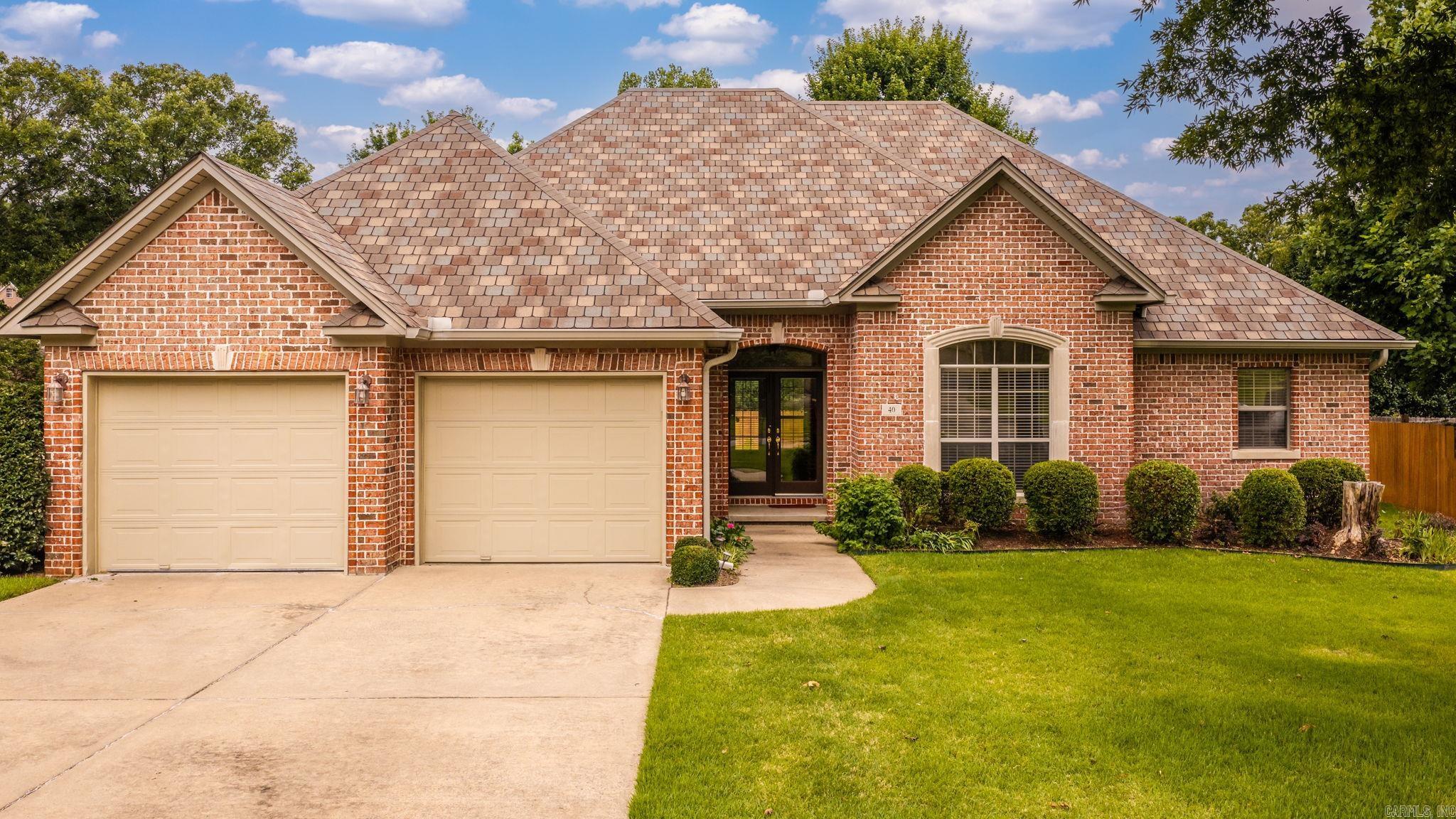 Tucked along a quiet street in coveted Aberdeen, this all-brick home makes its first impression from the curb — manicured lawn, mature shade, timeless architecture. Step through the front door and the real story begins. Sunlight pours across gleaming hardwood floors that flow room to room, gathering in a great room anchored by a classic brick fireplace and custom built-ins, where French doors frame the private, tree-lined backyard beyond. The kitchen is where form meets function: crisp white cabinetry, stone countertops, marble subway-tile backsplash, stainless appliances, and a center island made for slow Sunday mornings. A dedicated office offers the perfect work-from-home retreat, while the spacious primary suite delivers a true escape — tray ceiling, spa-inspired bath with jetted tub and separate shower, and a generous walk-in closet. Out back, a covered patio overlooks a deep, fully fenced yard backing to serene wooded green space — no rear neighbors, just breathing room. Minutes from the neighborhood pool, top schools, shopping, and dining. Best of all, the big updates are done — renovated kitchen, real hardwoods, quality bones.