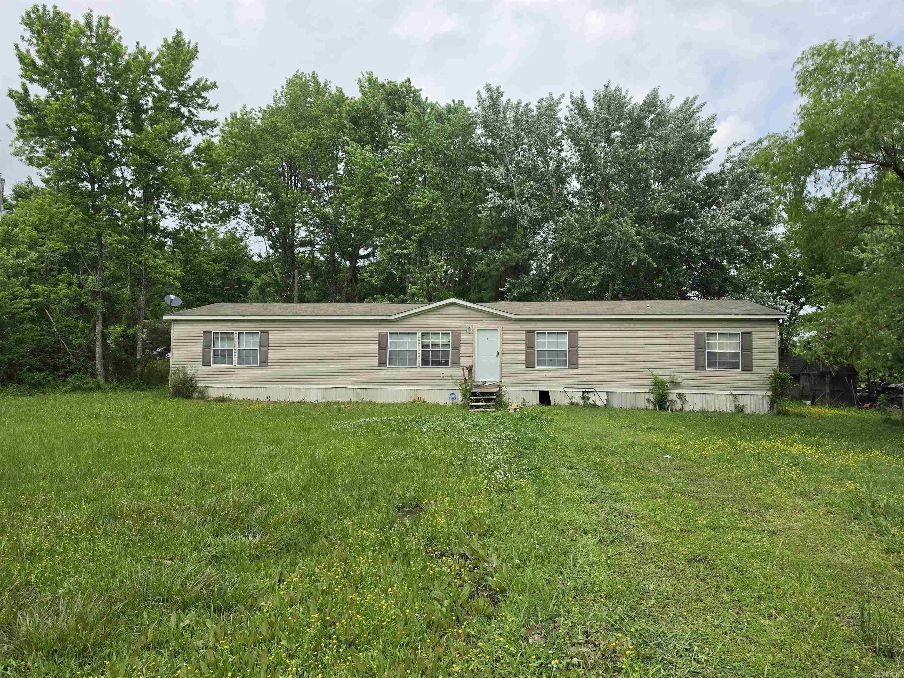 This huge 4-bedroom double wide home offers plenty of space and comfortable living on a full 1-acre lot. The standout primary suite features a large ensuite bathroom with double sinks, a relaxing soak tub, a walk-in shower, and a generous walk-in closet, perfect for a true retreat. The kitchen is a cook's dream with tons of cabinetry, a large island for prep and gathering, and a convenient walk-in pantry. Also enjoy cold nights with the woodburning fireplace. The layout flows well for both daily living and entertaining. The home sits on a full acre, giving you room to garden, add outdoor features, or simply enjoy some privacy. It’s in good condition and doesn’t need major work; you can move in right away and make improvements gradually as you go, turning it into exactly what you want over time. Cash or conventional financing only. No owner financing or FHA/VA. Survey on MLS. Sold as-is