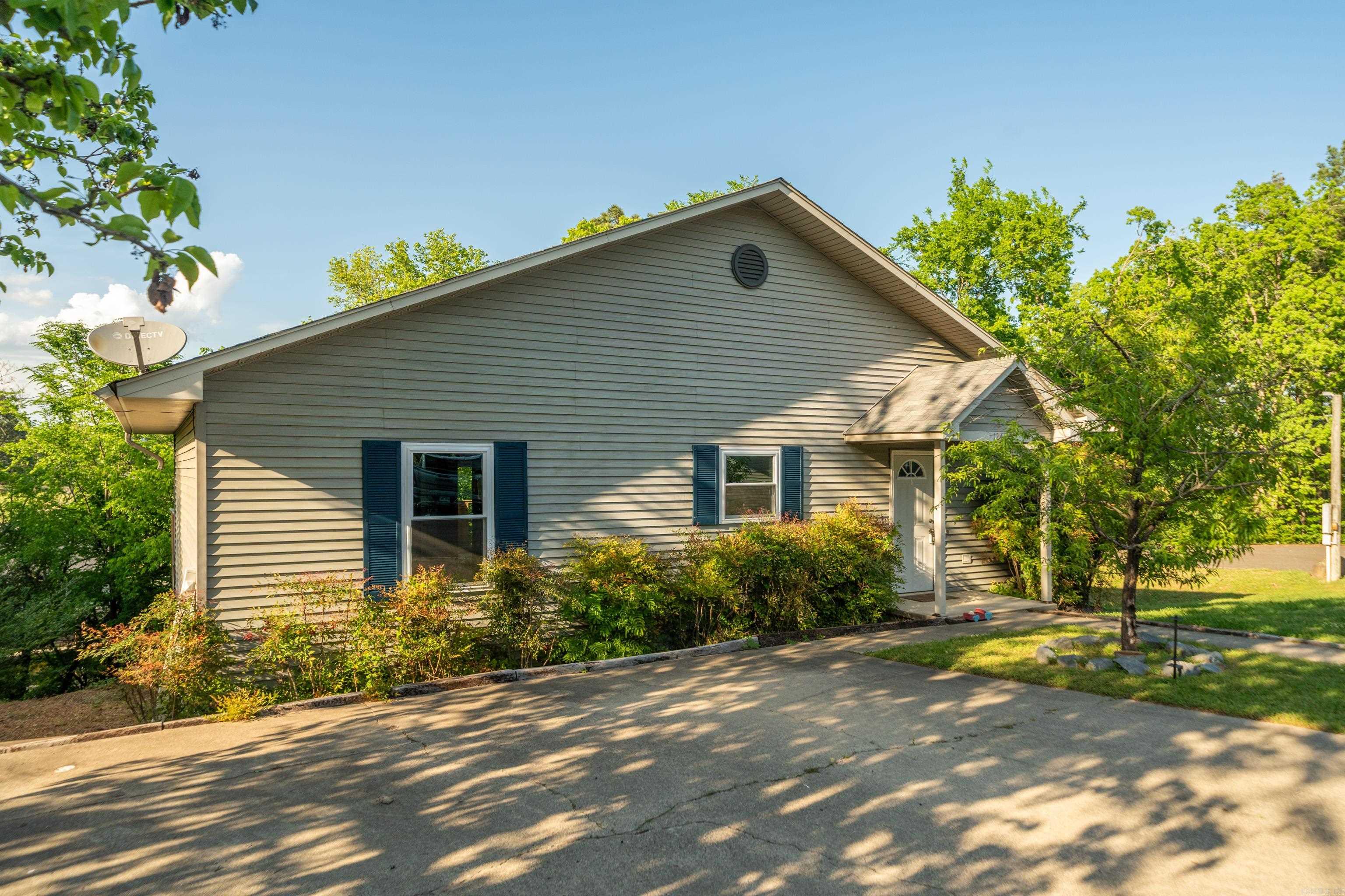 Beautiful 3-bedroom, 2-bath home overlooking Lake Hamilton with an open, airy floorplan and expansive windows that provide excellent natural light and lake views. This single-story layout features large glass doors that open onto your deck overlooking the lake in two of the three bedrooms as well as the living room area creating a seamless indoor-outdoor feel. Located outside the city limits, this property is eligible for short-term rental use, offering strong investment potential or the ideal setup for a personal lake retreat. Enjoy access to Lake Hamilton for boating and recreation. A rare opportunity to own a lake-view property with flexible use options and direct water access amenities.
