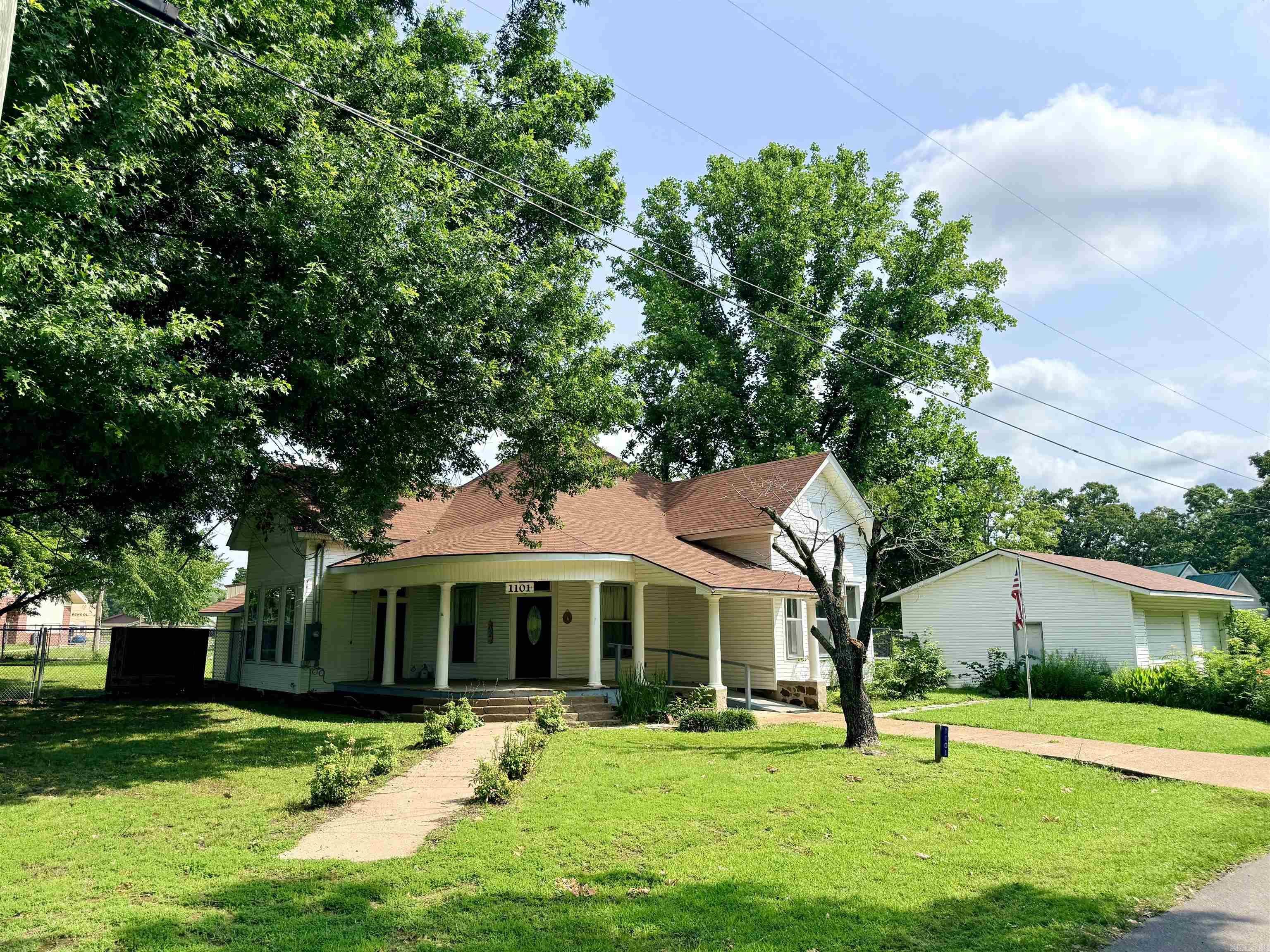Do you love the charm and character of a historic house? Take a look at this 3/2 home, beautifully designed and ready for its new owner. This 1427 sq foot house offers 3 bedrooms, 2 bathrooms, separate laundry area and an approximate 22x30 detached garage/shop. Spacious fenced yard, new chain link. Inviting front porch to sit with your morning coffee. Convenient to the school district as well as Dollar General in town. Roof is less than 4 years old, HVAC 6 yrs old and water heater 4 yrs old. Take a look!