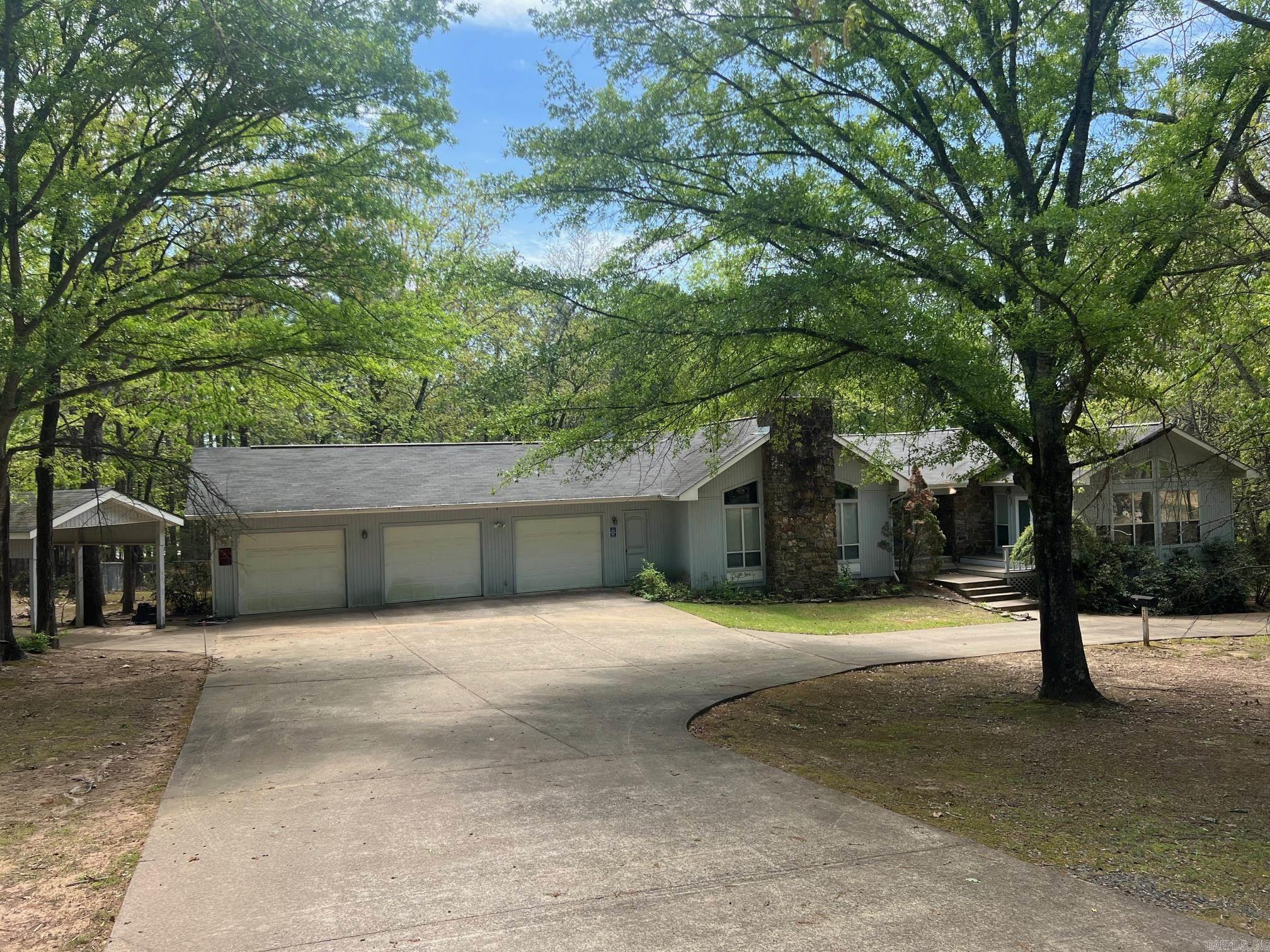 Wonderful home with 5 acres (3 lots), 4 bedrooms, 2.5 baths, nice fenced area for dogs, boat carport, 3 car garage, carport, beautiful setting in an very nice neighborhood near the lake.  Home has a bonus room that could be nice office or sunroom, 2 fireplaces, double oven, breakfast bar nice deck across the back and wildlife galore!  Don't let this dream home pass you by.