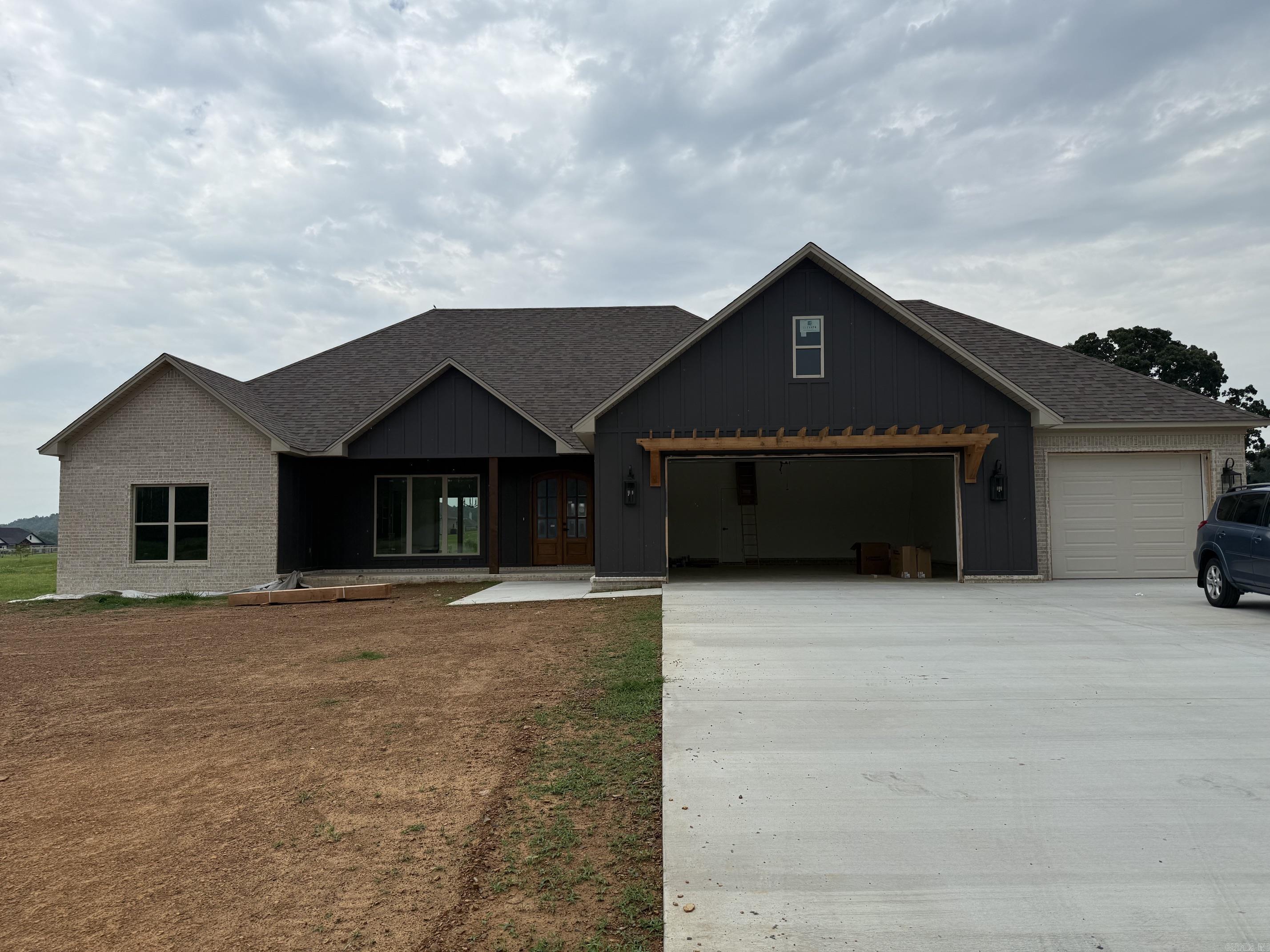 Welcome to this beautiful new construction home set on a spacious 1-acre lot. This thoughtfully designed 4-bedroom, 2.5-bath home features an inviting open-concept layout perfect for both everyday living and entertaining. The living area flows seamlessly into a stunning kitchen with custom cabinetry, a large island, and plenty of workspace. Enjoy natural light throughout, highlighted by expansive sliding glass doors leading to a covered back porch—ideal for relaxing or hosting guests.  The exterior showcases a timeless blend of brick and modern accents, complemented by a welcoming front porch. Inside, you’ll find quality craftsmanship, stylish finishes, and a functional split-bedroom floor plan offering privacy and comfort. The generous lot provides ample space for outdoor activities, future additions, or simply enjoying the peaceful surroundings.  Don’t miss the opportunity to own this brand-new home with modern design and room to grow!