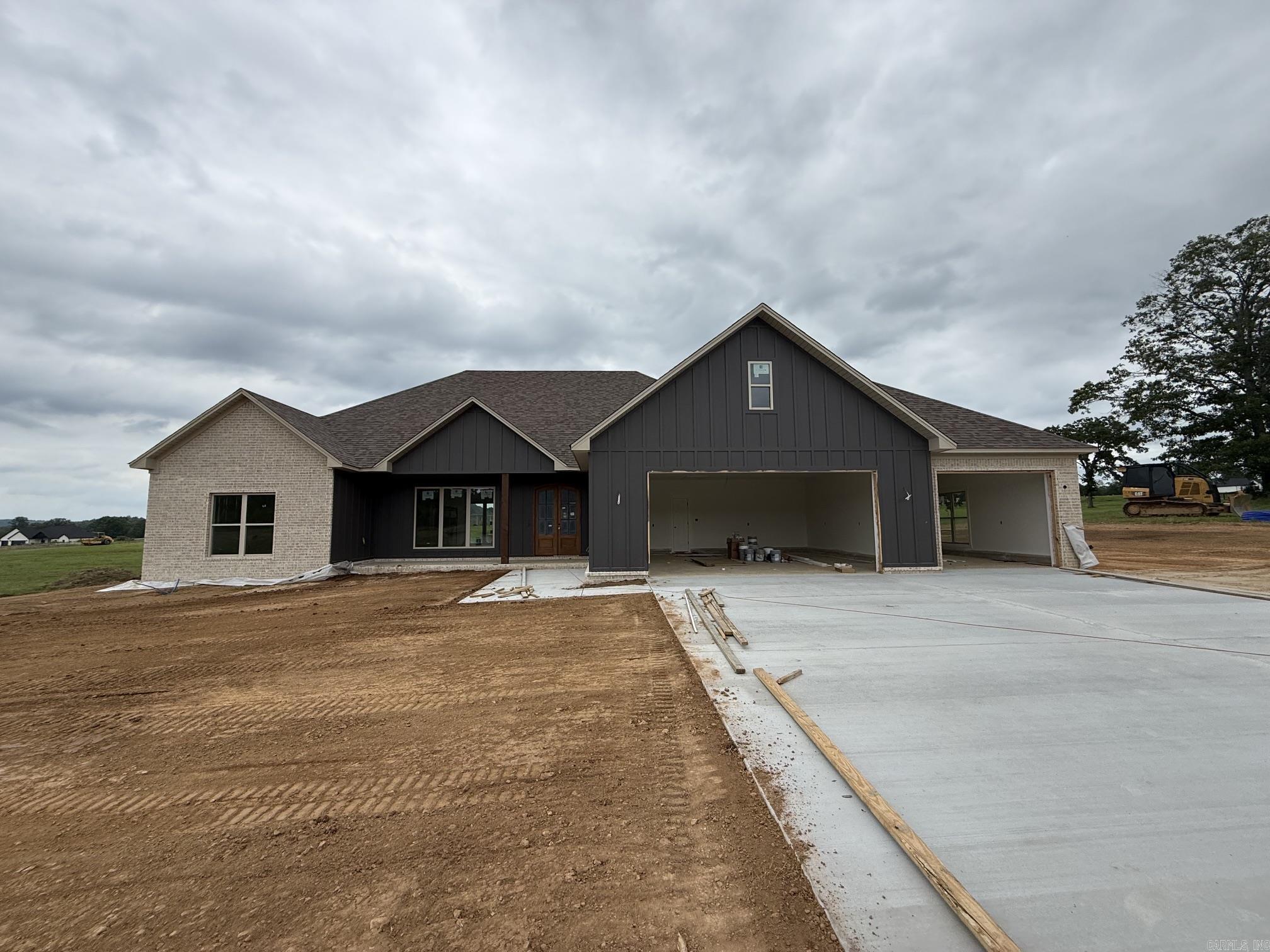 Welcome to this beautiful new construction home set on a spacious 1-acre lot. This thoughtfully designed 4-bedroom, 2.5-bath home features an inviting open-concept layout perfect for both everyday living and entertaining. The living area flows seamlessly into a stunning kitchen with custom cabinetry, a large island, and plenty of workspace. Enjoy natural light throughout, highlighted by expansive sliding glass doors leading to a covered back porch—ideal for relaxing or hosting guests.  The exterior showcases a timeless blend of brick and modern accents, complemented by a welcoming front porch. Inside, you’ll find quality craftsmanship, stylish finishes, and a functional split-bedroom floor plan offering privacy and comfort. The generous lot provides ample space for outdoor activities, future additions, or simply enjoying the peaceful surroundings.  Don’t miss the opportunity to own this brand-new home with modern design and room to grow!
