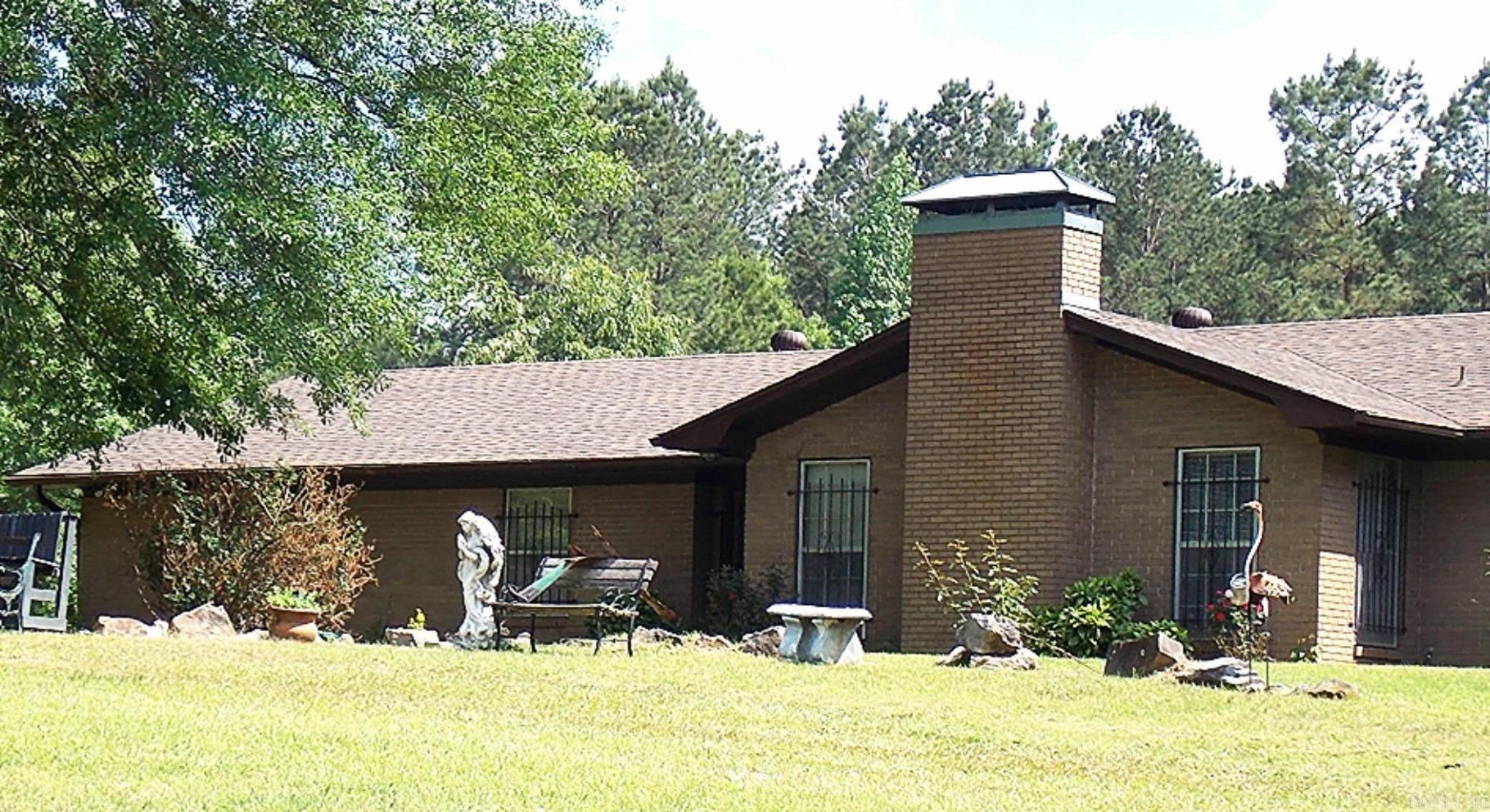 Welcome to this charming 1969 modern home, where vintage character meets contemporary comfort. Step inside to discover a sunken living room, beautiful beamed ceilings, and a cozy entryway nook. Enjoy meals in the inviting breakfast room or host elegant dinners in the formal dining room, complete with charming window bench seating.  The bathrooms feature stylish tile showers and half-tiled walls, while the updated kitchen boasts a new electric stove top, a separate oven, a sleek Samsung refrigerator, and a dishwasher.  With four spacious bedrooms, there's plenty of room for everyone. The property sits on beautifully landscaped acreage, and the fully fenced backyard is perfect for gatherings, complete with a hot tub pad and hookups. The large back deck is ideal for family fun and peaceful evenings.  If you're looking for tranquility, space for family gatherings, or even to start your own little farm, this home is your perfect match. Plus, you'll have convenient amenities nearby, including a fire department, a Dollar Tree, and a gas station, all less than a mile away.