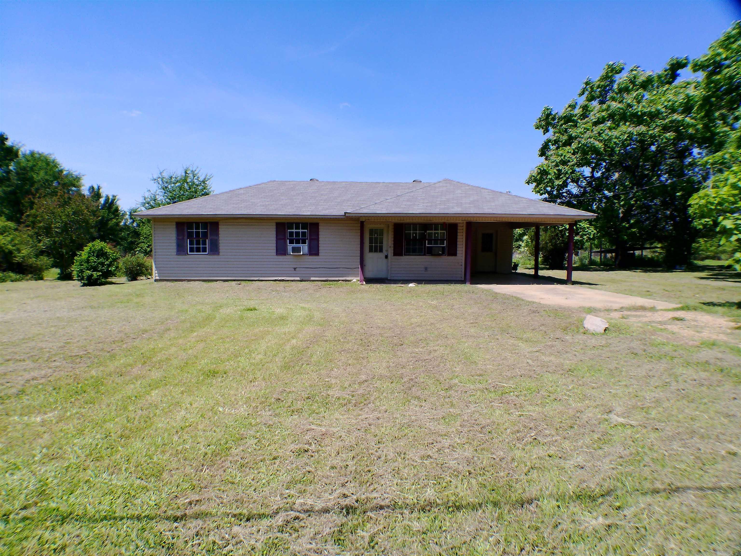 So much to love about this property and acre of land located just outside the city limits of Prescott, AR. The home site is LOVELY with a variety of trees and shrubs that bloom throughout the year and neighboring pasture land provides great privacy and wildlife watching. The home is cute with a functional layout including 3 bedrooms, 2 full bathrooms and a laundry room located off the kitchen and carport. Updates have been made in the past few years including new roof, carpets removed, concrete floors painted as well as several lighting fixtures being replaced. The potential to make this a dream first home or forever home is endless! Agents please see comments for extra information.