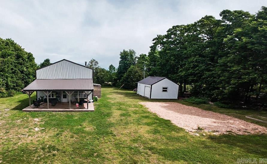 Only a few minutes outside the small-town charm of downtown Leslie, turning off Hwy 65 just south of the bridge for the Middle Fork of the Little Red River, you will find a private homestead nestled in the woods, ready for its new family! The home, completed in 2022, offers a rustic-cabin feel with modern perks: 6-inch spray foam insulation for energy efficiency, easy-to-keep concrete and LVP floors, tongue-and-groove knotty pine walls and ceilings, and a wood stove. There are 3 bedrooms, 2 full bathrooms, and a large loft space open to the living area below. The beautiful vaulted ceilings make the space feel large and open, while the windows allow natural light to flood the living space.   The long, private driveway leads you to a 2-acre property that has a huge, grassy backyard perfect for outdoor lawn activities, a garden spot ready to grow your own, and over an acre of wooded property with the underbrush cleared - ready for you to make it your own!   If you dream of living amongst the beauty of the Ozark Mountains, balancing the peace of nature with access to public water and fiber internet - this place is one you don't want to miss.