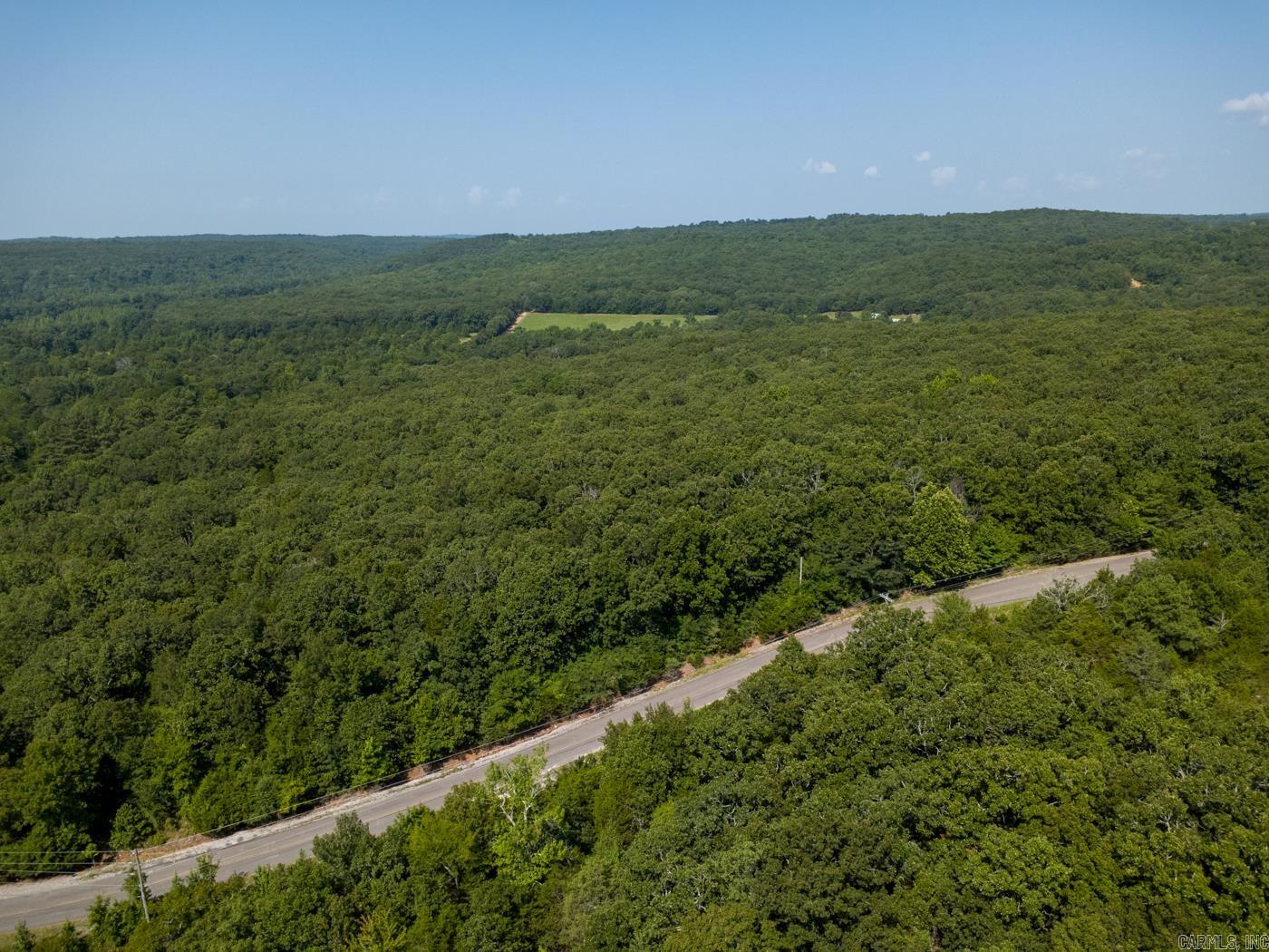 Welcome to Market 18.32 +/- acres just northwest of Bradford proper in western Jackson County. This wooded tract offers approximately 750 linear feet of paved frontage along Jackson County Road 1, creating convenient access to a private setting within rolling countryside. Mature pine and hardwood timber, varied elevations, and established wildlife habitat give the property strong recreational appeal, while the expansive road frontage adds versatility for future use. Entergy and Jackson Regional Water service the surrounding area; buyers should verify availability and connection requirements for the property. Mineral rights do not convey. The aerial views showcase a broad canopy of mature woods and scenic rural surroundings. Whether you are looking for hunting land, a weekend retreat, or a long-term land investment, this tract delivers acreage, access, and opportunity in one package. Call today to walk the property and make an investment in tomorrow.