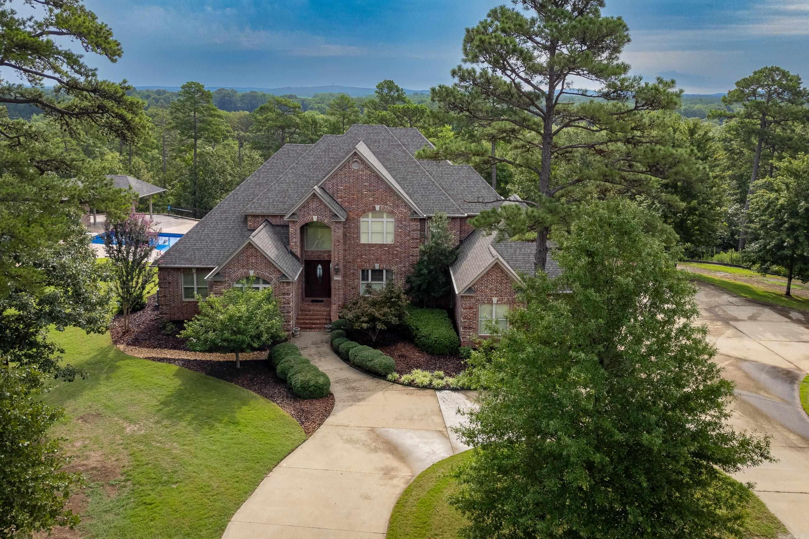 Spectacular home with pool on acreage in Roland just past Waterview Estates. Five Bedrooms with Primary and Guest Bedrooms on main level. All brick construction with 3-car side-loading garage. Beautiful vista views from home and pool area. Additional property includes buildable lot on corner, hay field, enormous shop, and so much more on 24 +/- acres. All parcels sold together as one unit. Super special! See Agent remarks.