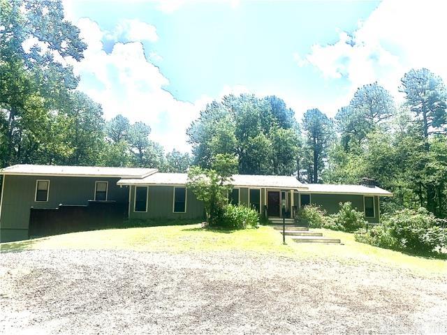Enjoy country in the Conway city limits on 5 ACRES!  A lovingly kept home with 4 bedroom and 3 baths. It has more storage than you will be able to use. The primary bedroom has an enclosed sunroom with minisplit and elec fireplace.  2 Walkin closets and gas logs fireplace. There is a craft room/bedroom en suite. It is decked out with cabinets, drawers and lots of storage.  It opens to the back deck. The family room is vaulted ceiling with big windows and wonderful pull blinds and a gas log fireplace. The kitchen is a chef's delight with the biggest island for lots of family gatherings. One wall is a built-in buffet. 2 dishwashers, 2 sinks, 2 disposals, pull out drawers everywhere and a large area for a big table. The windows surrounding the dining area bring in lots of light. The downstairs garage has a safe room and a workshop along with more storage areas!   Outside there is a fenced in area for your pets and storage buildings. A rose garden tops this off in the back. There is also a covered area for more cars, campers, ATV's, boats and your other toys. A portable Generac restores lights and frig just in case of a power outage. 1 Yr HW to buyer at closing.  Agents see remarks!