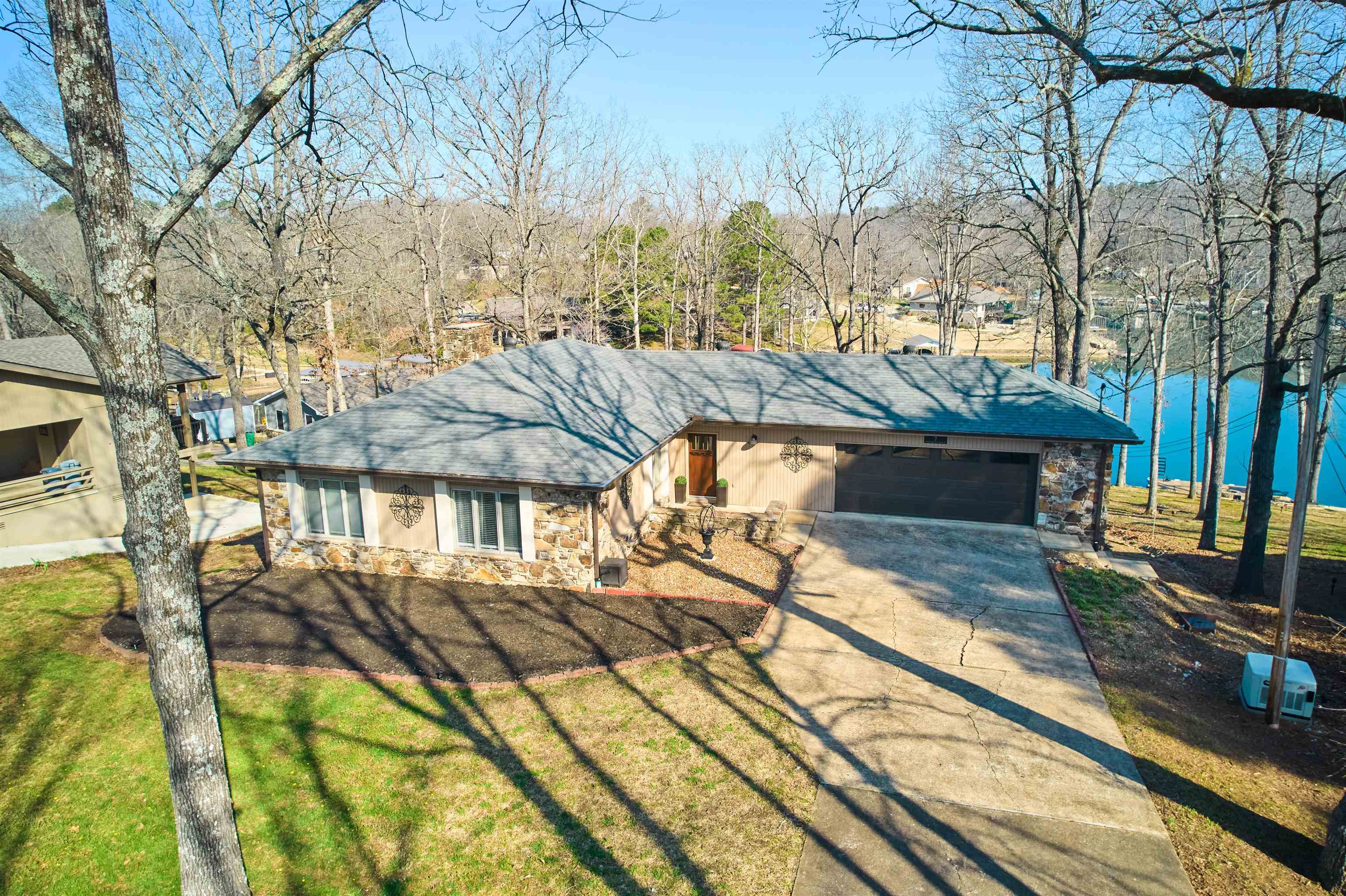 This EXQUISITE Lake Thunderbird Lake Front Home is on the market w/BONUS full house Generac! The main level has a gourmet kitchen, living room, dining area & outside enclosed covered deck, two guest (or office) rooms & the primary bedroom & bath &half. Kitchen has a stainless steel hammered drop-in sink w/disposal, stone counter tops, high-end cabinetry, under counter lighting, soft closed drawers, LG electric ThinQ smart 5 burner range-with a conventional/convection/ air fryer oven. Kitchen includes LG ThinQ smart microwave, LG ThinQ dishwasher & LG French door refrigerator/freezer & LG large capacity full size stackable washer/dryer. SPECIAL features-hammered stainless steel farm sink & large kitchen island w/outlets & NEW light fixtures throughout! The spacious living room/dining room has a wood burning fireplace & vista views-then leads to the screened porch-Great for entertaining! Downstairs has a guest room, bath, living room plus 24x30 Bonus room for games or storage. There is a covered patio & sidewalk that leads to the lake covered dock w/swim platform w/ladder. Partially fenced back lawn for your fur babies. PLUS lake amenities! This Beautiful home could be yours!!!