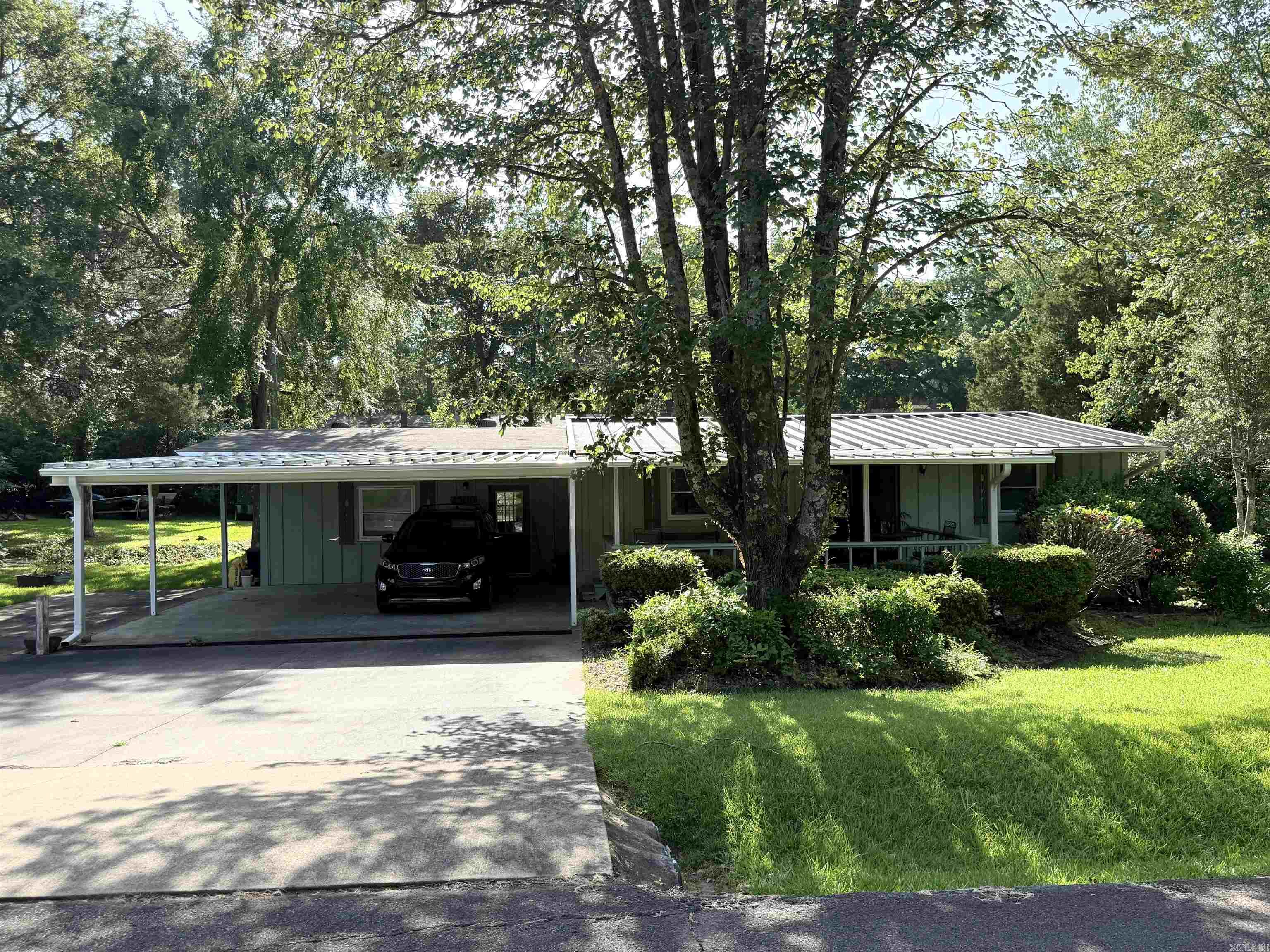 Great starter home or investment property!!  This 2 bedroom, 2 bath property has lots of curb appeal.  Bonus room could be used as a 3rd bedroom. Sit back and enjoy the nice covered deck on the front or walk to the end of the street to the lake.  Nice wet weather creek behind the property and a small shed.  Convenient to lake, shopping and schools.  Property is currently rented, so please give 24 hour notice to show. (One bedroom photo was AI enhanced to remove storage items from the picture)
