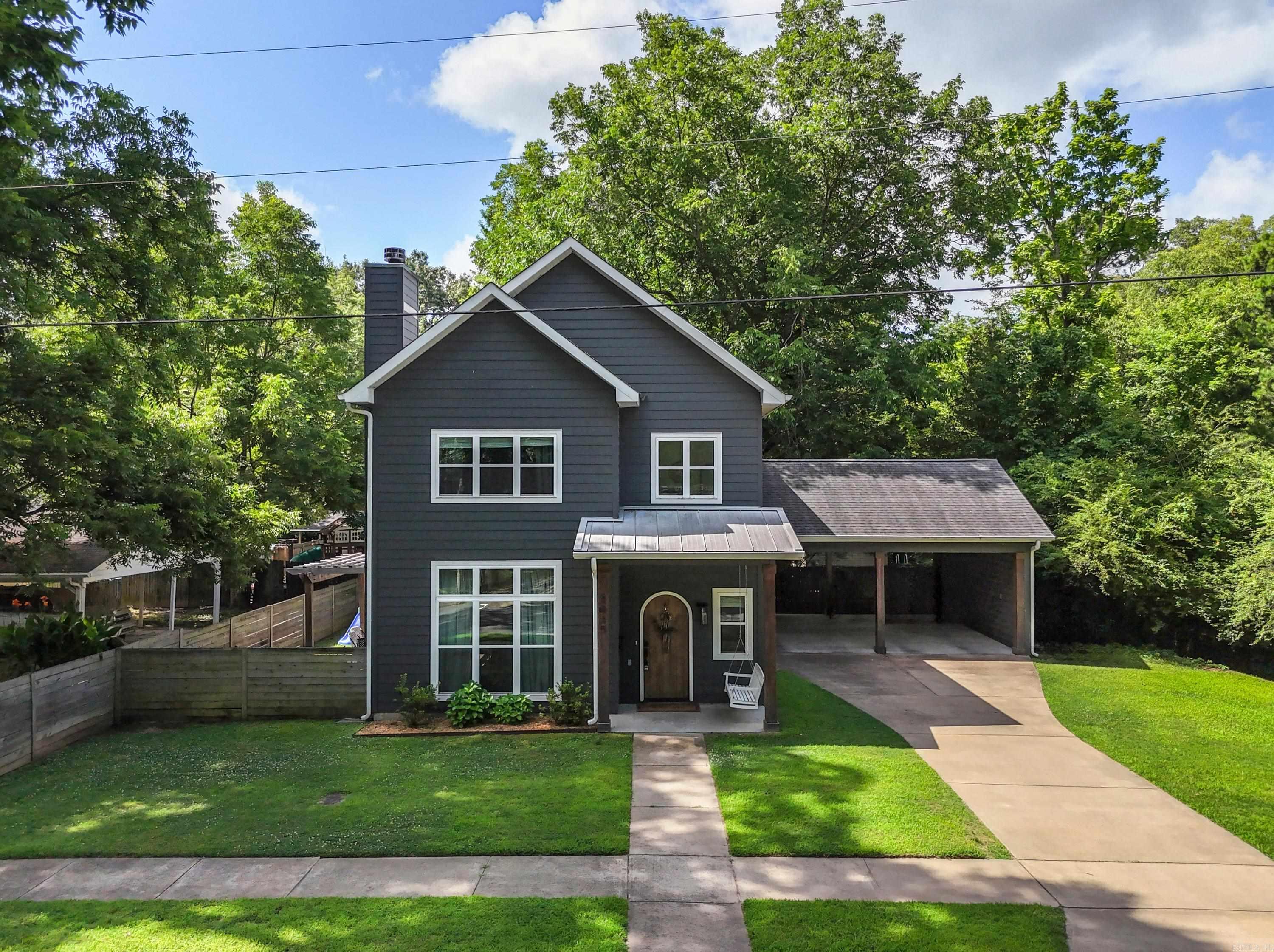 Live where Conway comes to life. This custom 2018-built home sits just steps from downtown's best coffee shops, restaurants, and local shops. Inside, 1,700 thoughtfully designed square feet offer an easy, livable flow. The main level is built for everyday life and entertaining alike, with open living spaces, a cozy wood-burning fireplace, a dedicated downstairs office, and a convenient half bath.  The kitchen — fully updated in 2024 and anchored by a gas range — is ready for everything from quick weekday meals to weekend gatherings.  Durable LVP flooring runs throughout, blending style with low-maintenance practicality. Upstairs you'll find all three bedrooms, two full baths, and a dedicated laundry room — keeping the living and sleeping spaces smartly separated. Outside, the .2-acre lot lives large. Relax under the spacious covered back patio, sip your morning coffee on the pergola-shaded side patio, and enjoy the privacy of a partially fenced yard. Two-car carport with an integrated storage shed and bonus attic space above carport.  This one will go fast! Schedule your showing today!