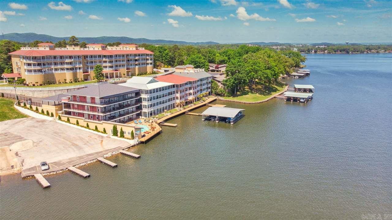 Absolutely stunning southeast facing penthouse condo on Lake Hamilton w/panoramic water views across the entire front of the unit. This unit features a spacious kitchen w/gorgeous cabinetry, granite countertops, large pantry, wine cabinet & top of the line appliances. 2 large lake side living areas, full size wet bar w/seating, open dining area plus more. The master suite in this condo is unmatched and features a large second suite features a private bath w/shower & jetted tub plus walk-in closet.