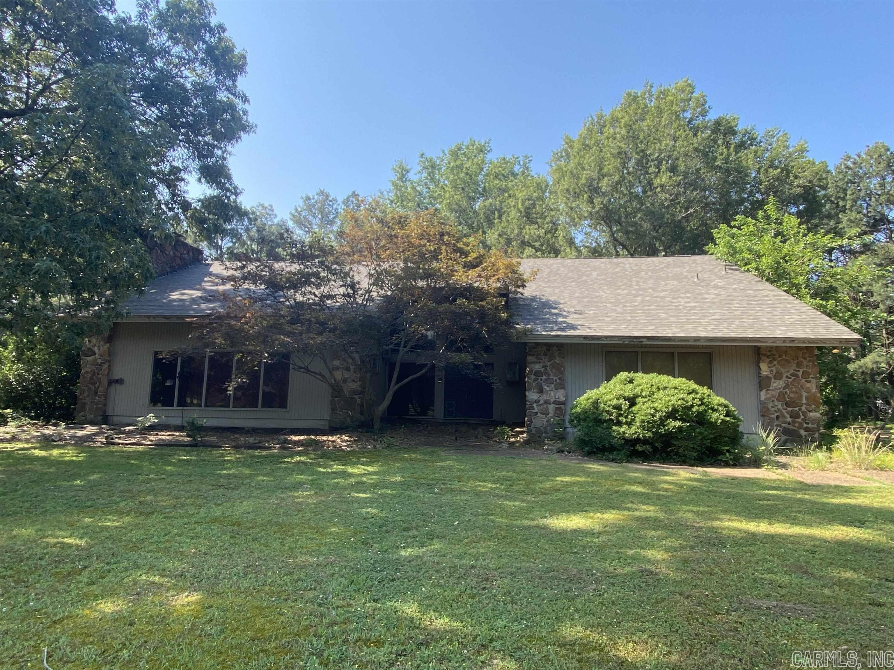 Are you looking for a hidden gem? This diamond in the rough is situated on a beautifully shaded, 2.5 acre lot in a quite country setting located in the heart of Weiner, Arkansas. The Contemporary design features of this home are unlike homes of today. A soaring vaulted, tongue and groove ceiling and rock fireplace draw you to the spacious great room. Built-ins are plentiful throughout and include designated private office space just off the two story foryer. A retro styled, eat-in kitchen boasts brick flooring and an abundance of cabinetry. Newer stainless applinaces include double ovens and built-in dishwasher, as well as a stainless farm sink. Other recent updates include a new roof in 2023 and a walk-in tile shower. A lofted second floor contains additional bedrooms, gameroom with bar and additional 1/2 bath. This home is priced to Sell as is and is awaiting it's new owners!